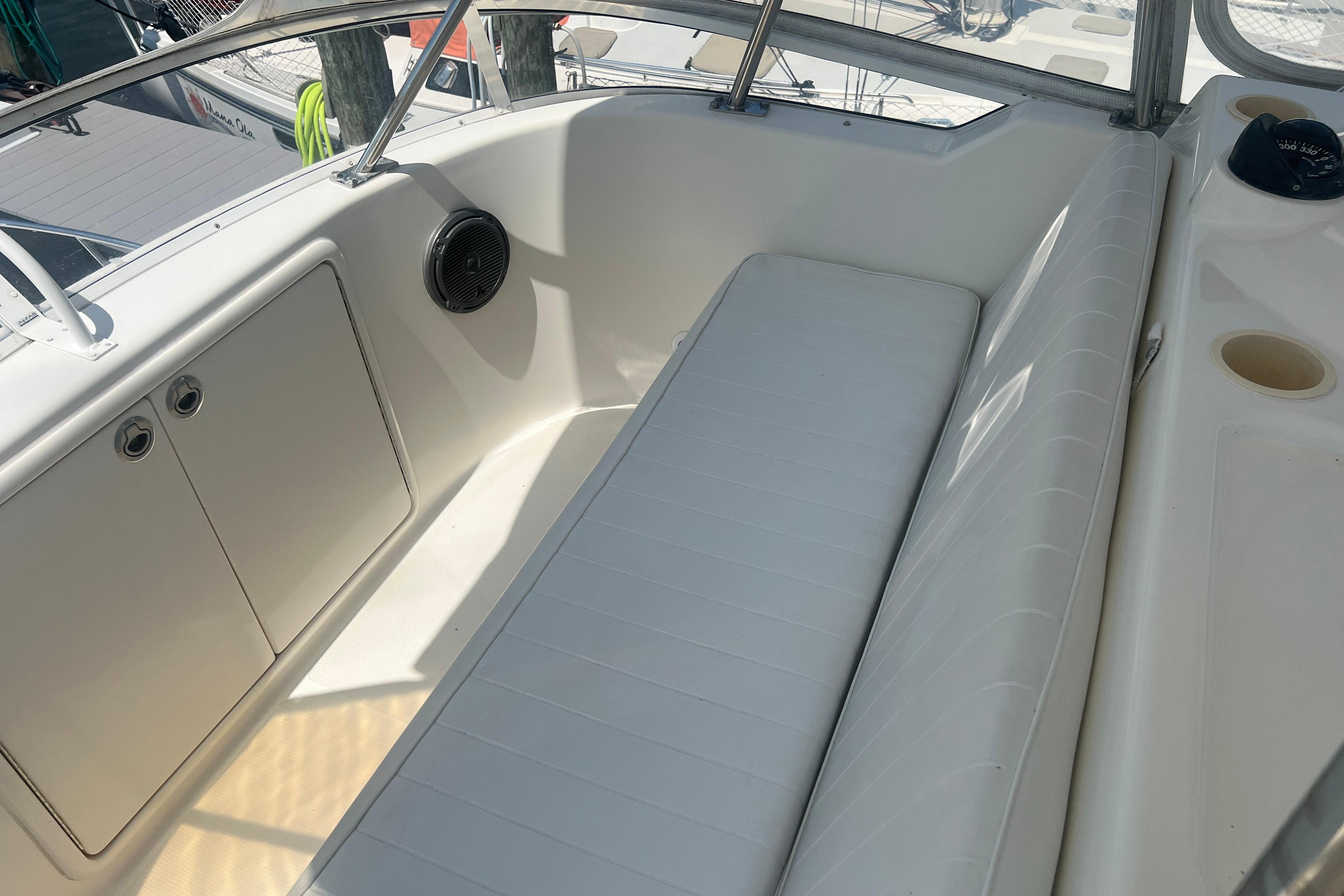 2007 Riviera 33 Flybridge interior with white seating and storage compartments.