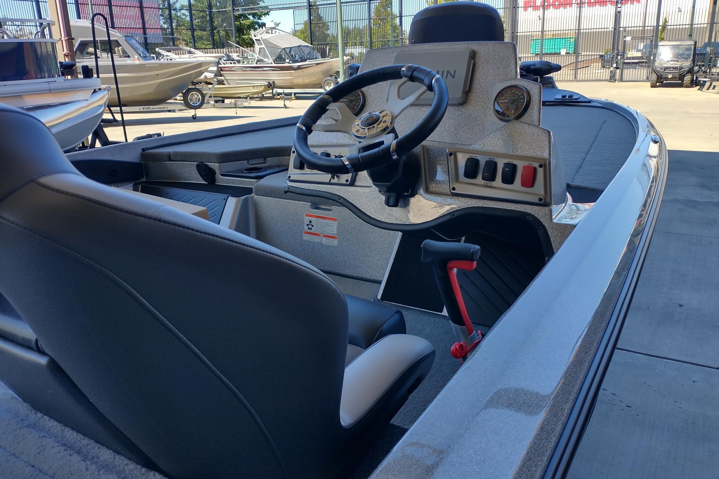 2026 Nitro Z18 Pro boat interior with steering wheel and control panel, parked outdoors.