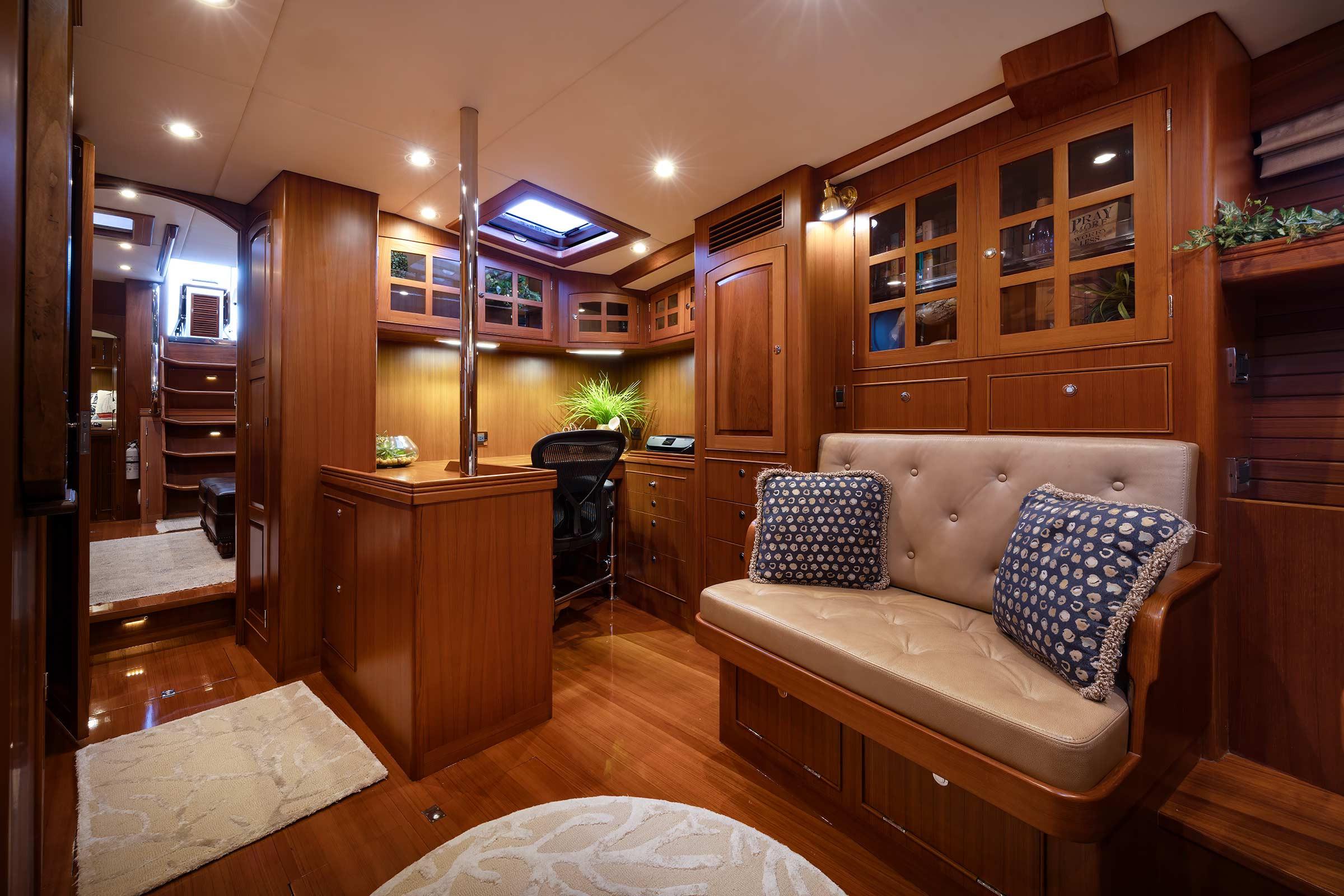 Luxurious interior of 2014 Hylas 63 yacht with elegant wood finish and plush seating.
