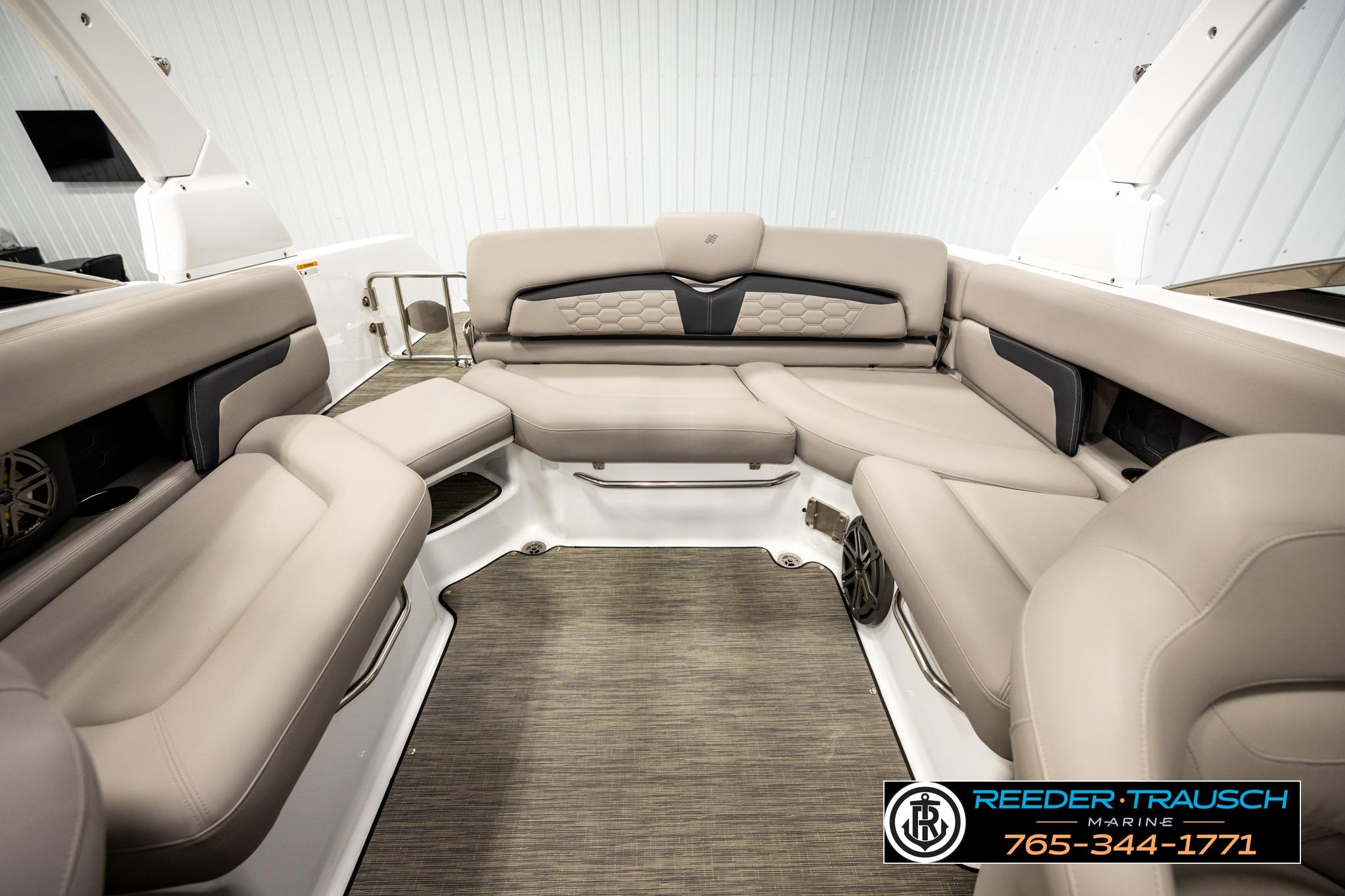 2024 FOURWINNS HD5 Surf boat interior with luxurious beige seating and modern design.