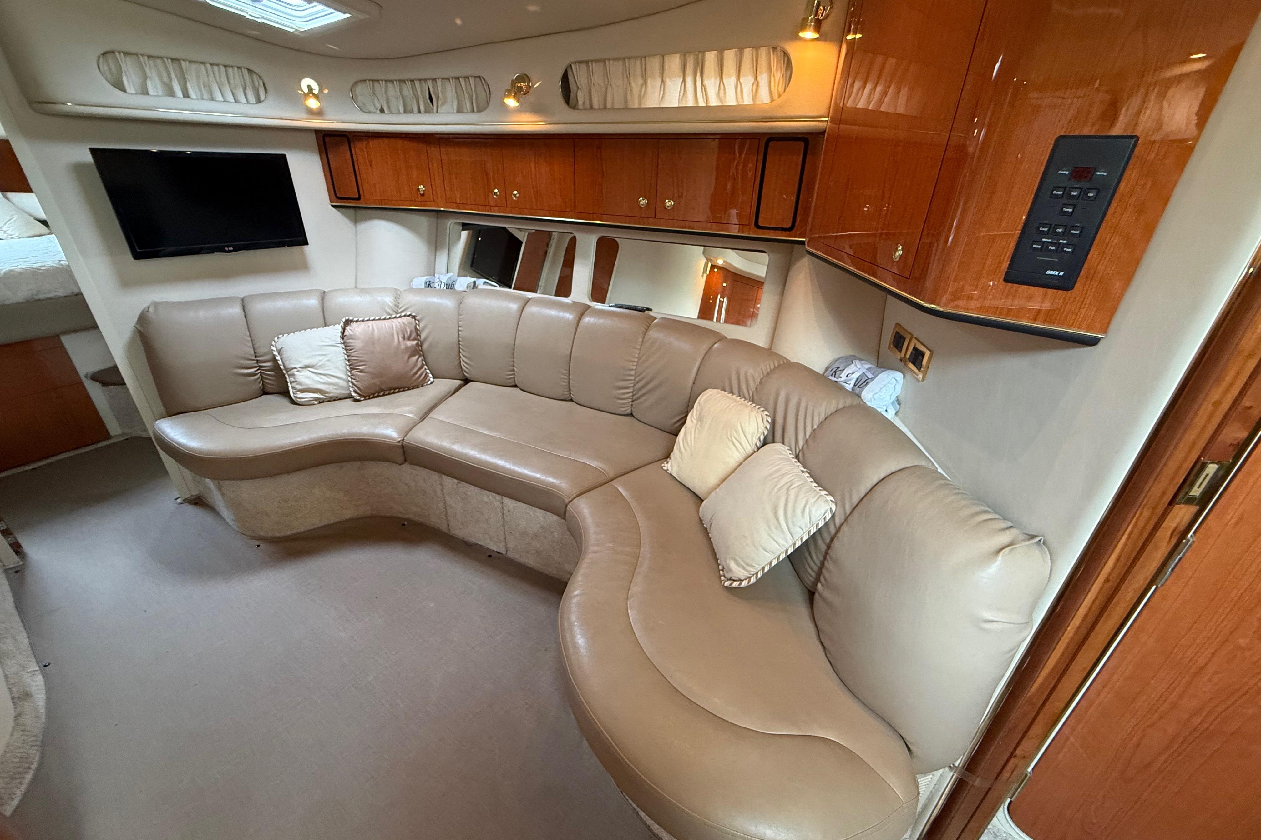 Luxurious interior of 1998 Sea Ray Sundancer 400 yacht with leather seating and wood cabinetry.