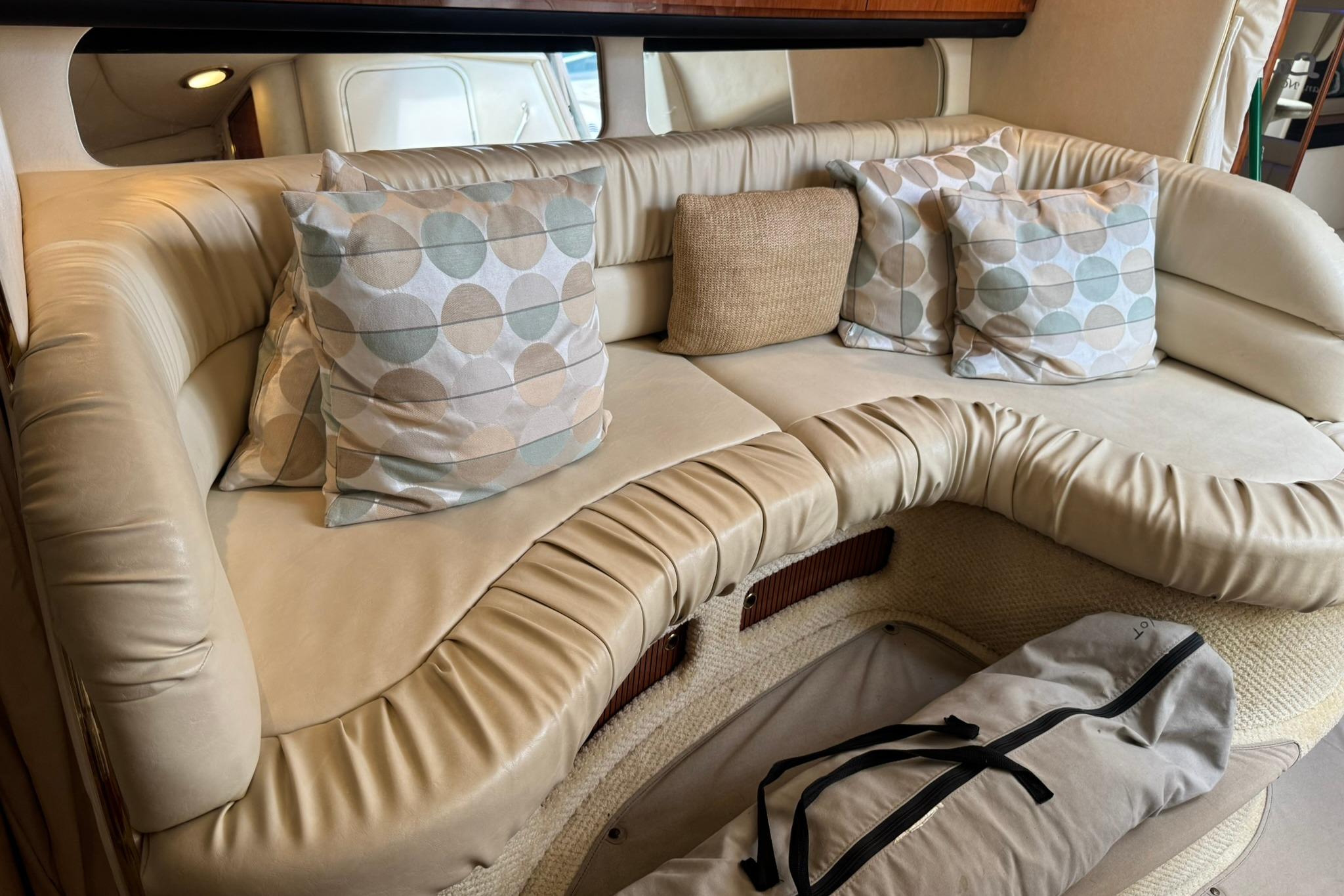 Luxurious interior seating of 2001 Sea Ray 340 Sundancer with decorative pillows.