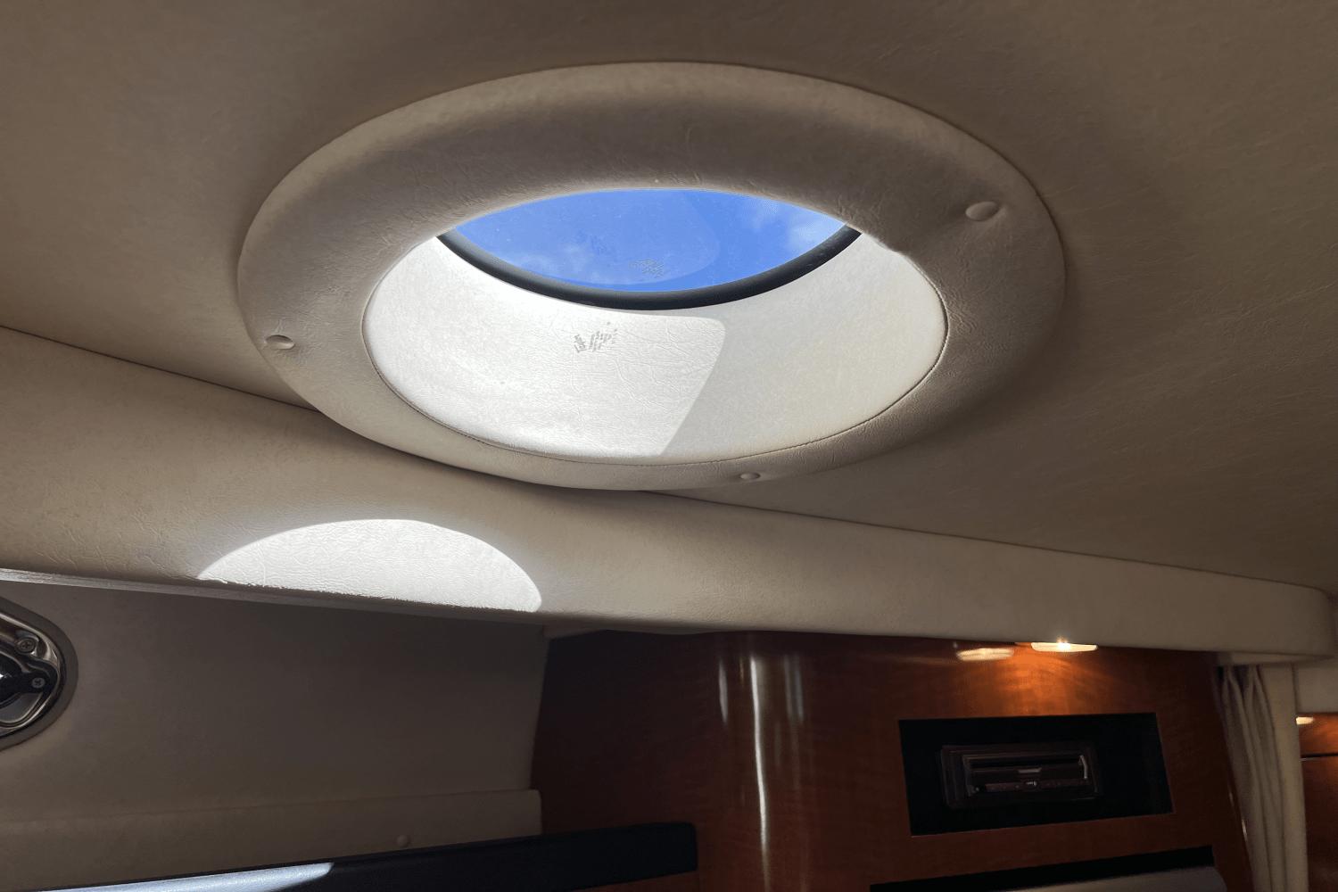Interior view of 2005 Sea Ray 340 Sundancer with circular skylight.