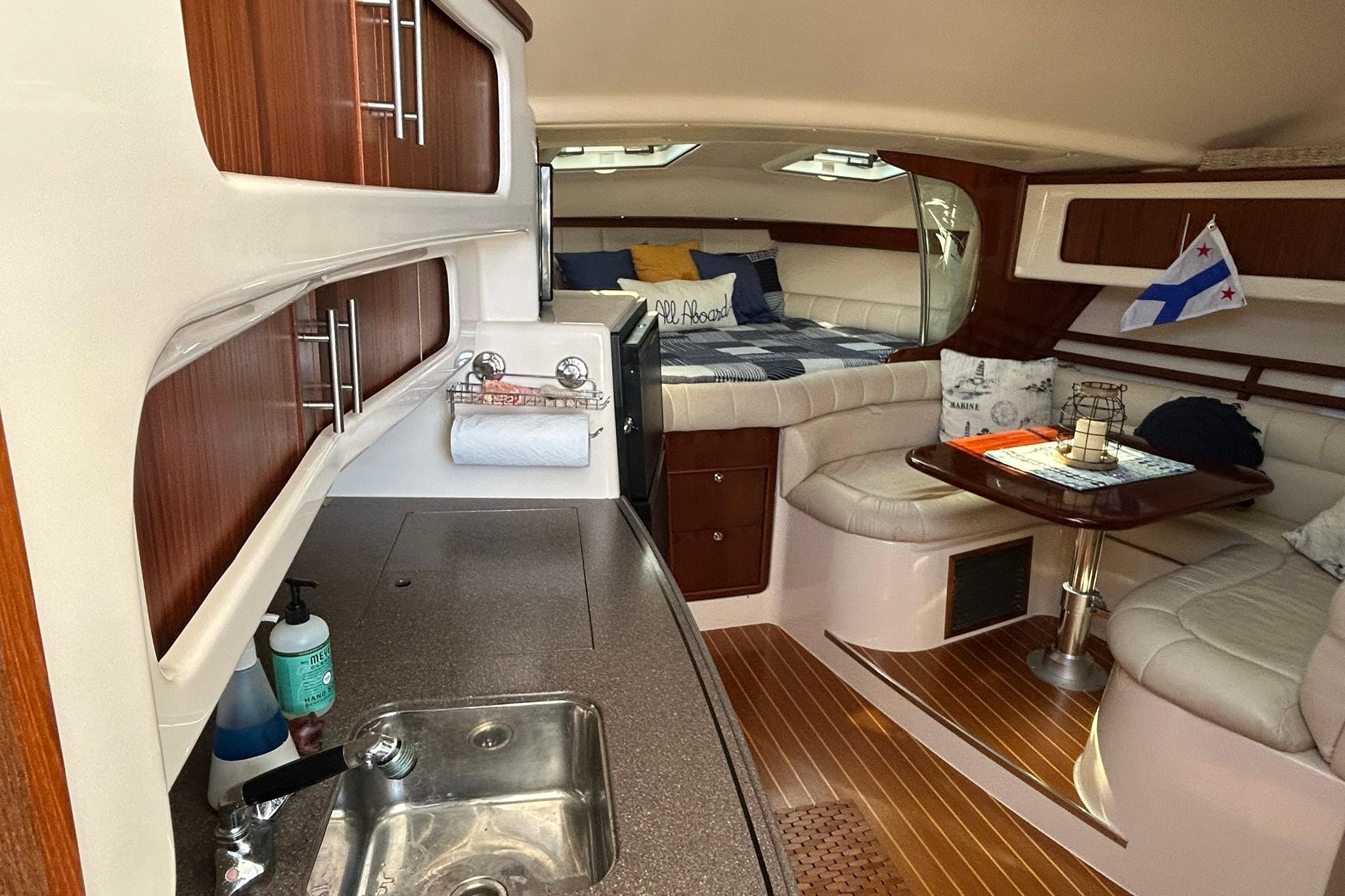 Luxurious 2007 Grady-White Express 360 cabin interior with kitchenette and cozy seating area.