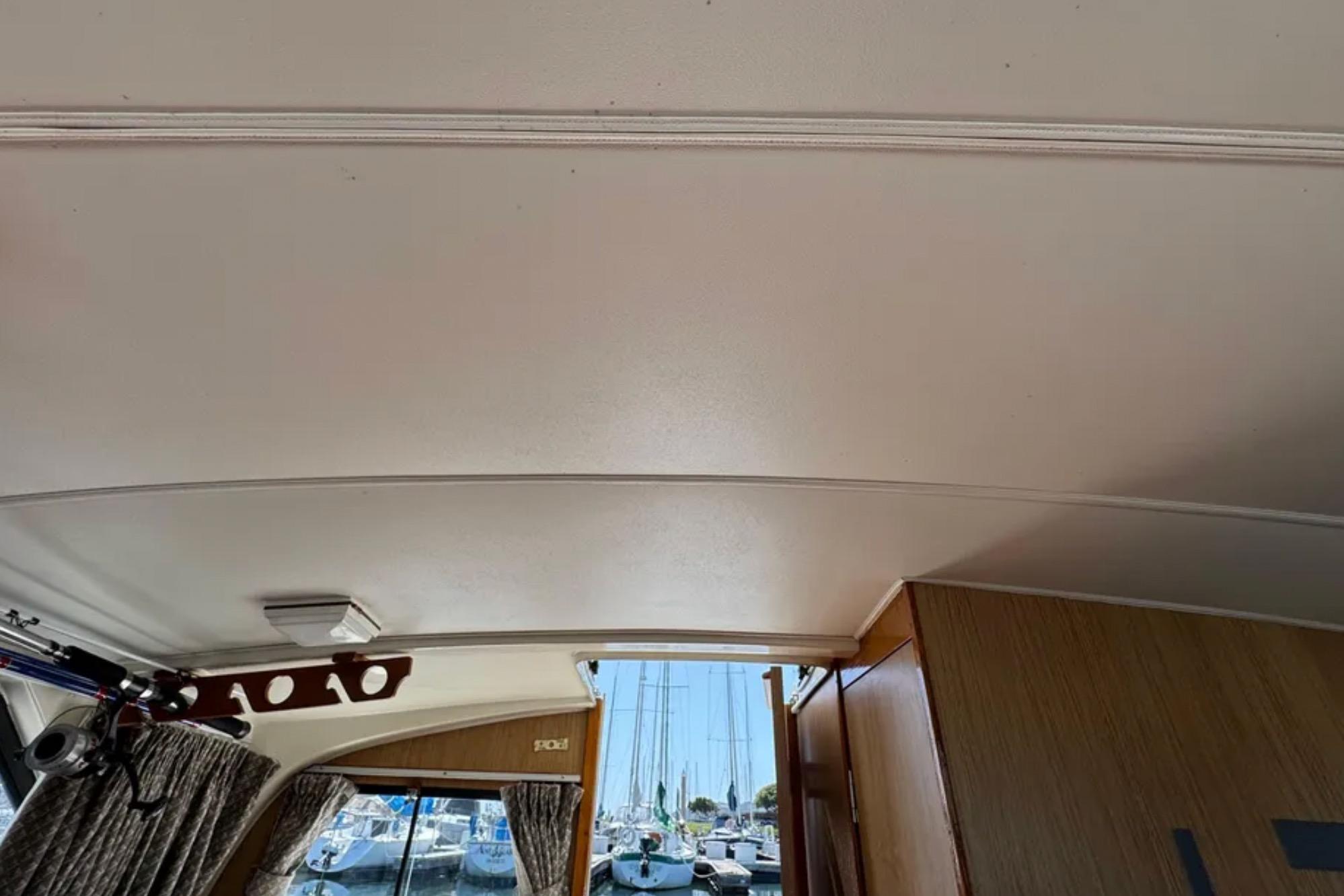 Interior view of 1988 Bertram 28 Sport Fisherman boat with visible ceiling and window.