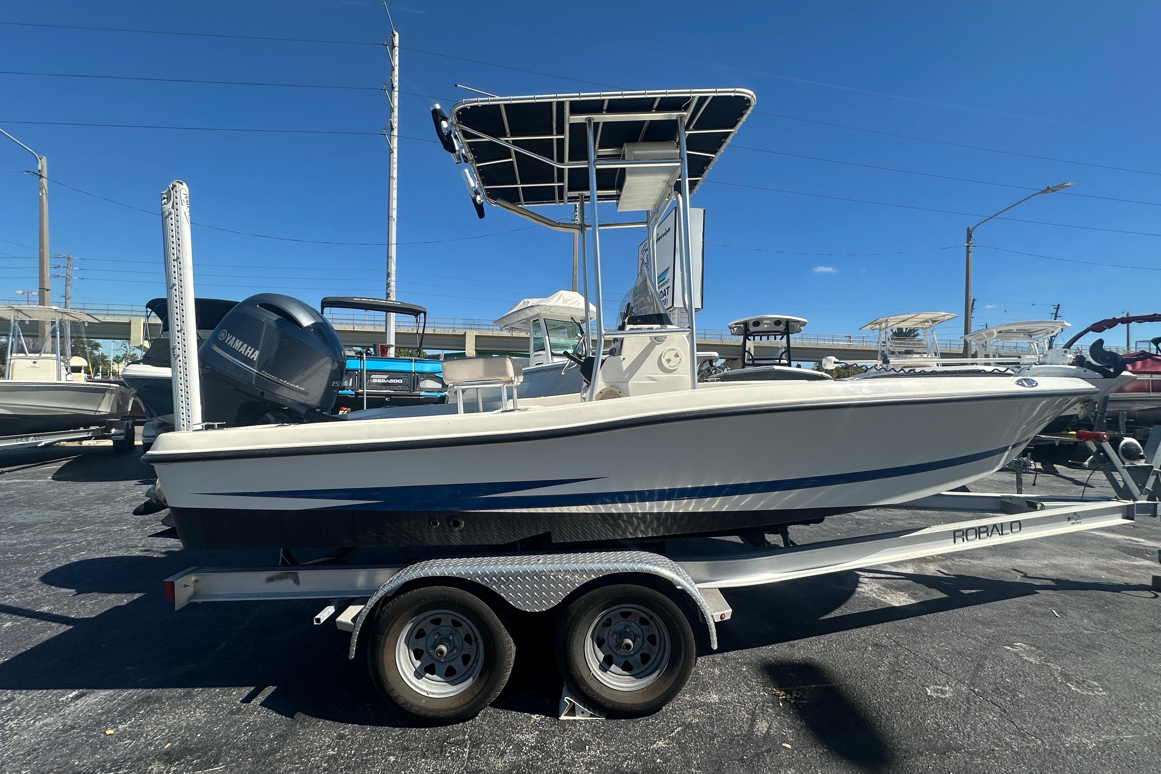 2003 Hydra-Sports 19 Bay Bolt boat on trailer, side view, clear sky background.