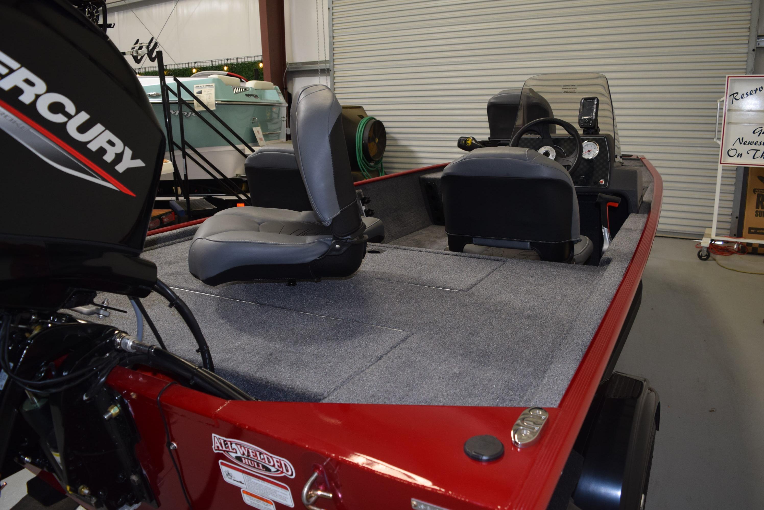 2026 Tracker Bass Tracker Classic XL boat interior with Mercury engine, featuring gray seating and dashboard.