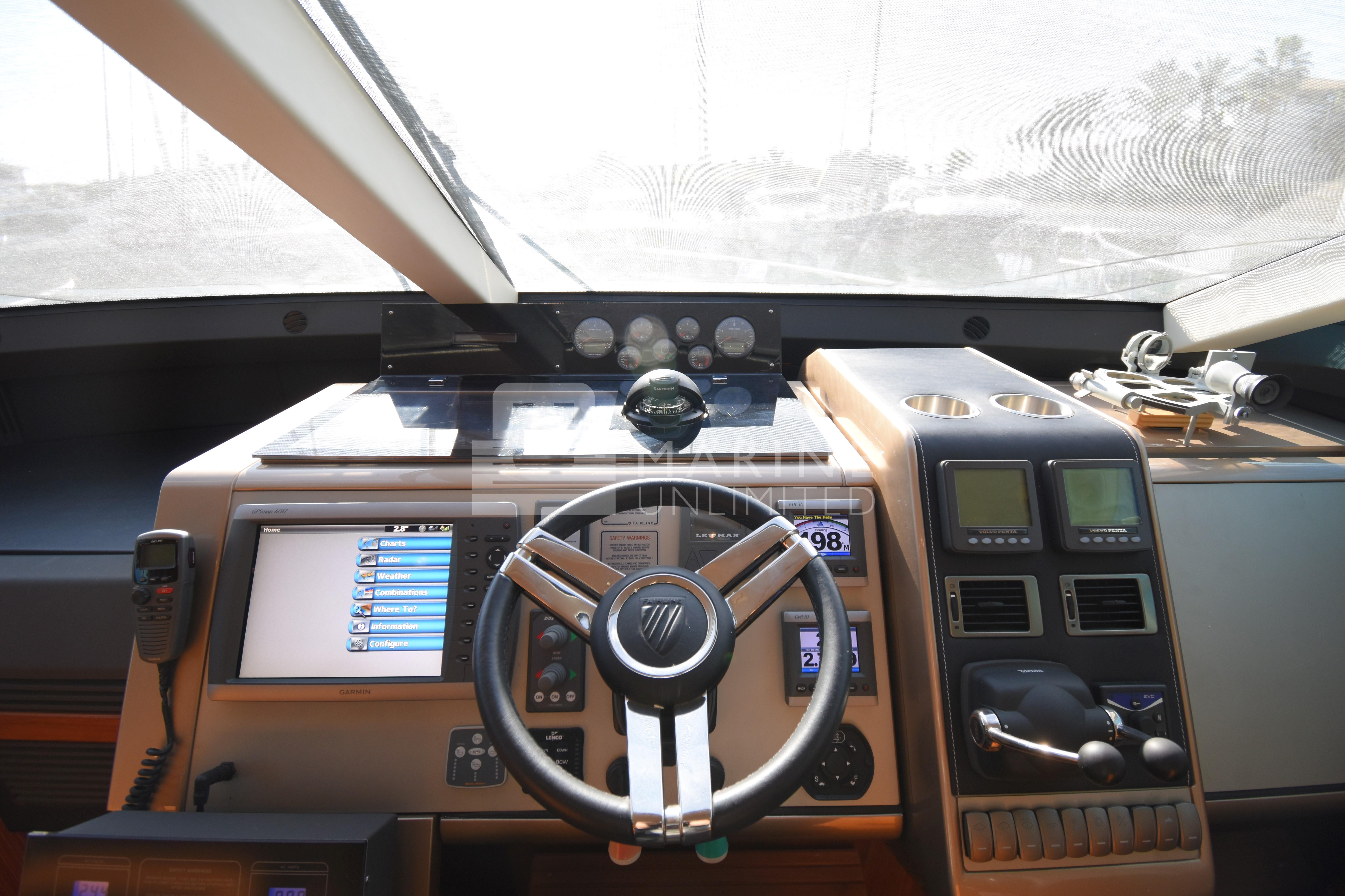 Cockpit of 2010 Fairline Squadron 55 yacht with modern navigation equipment and steering wheel.