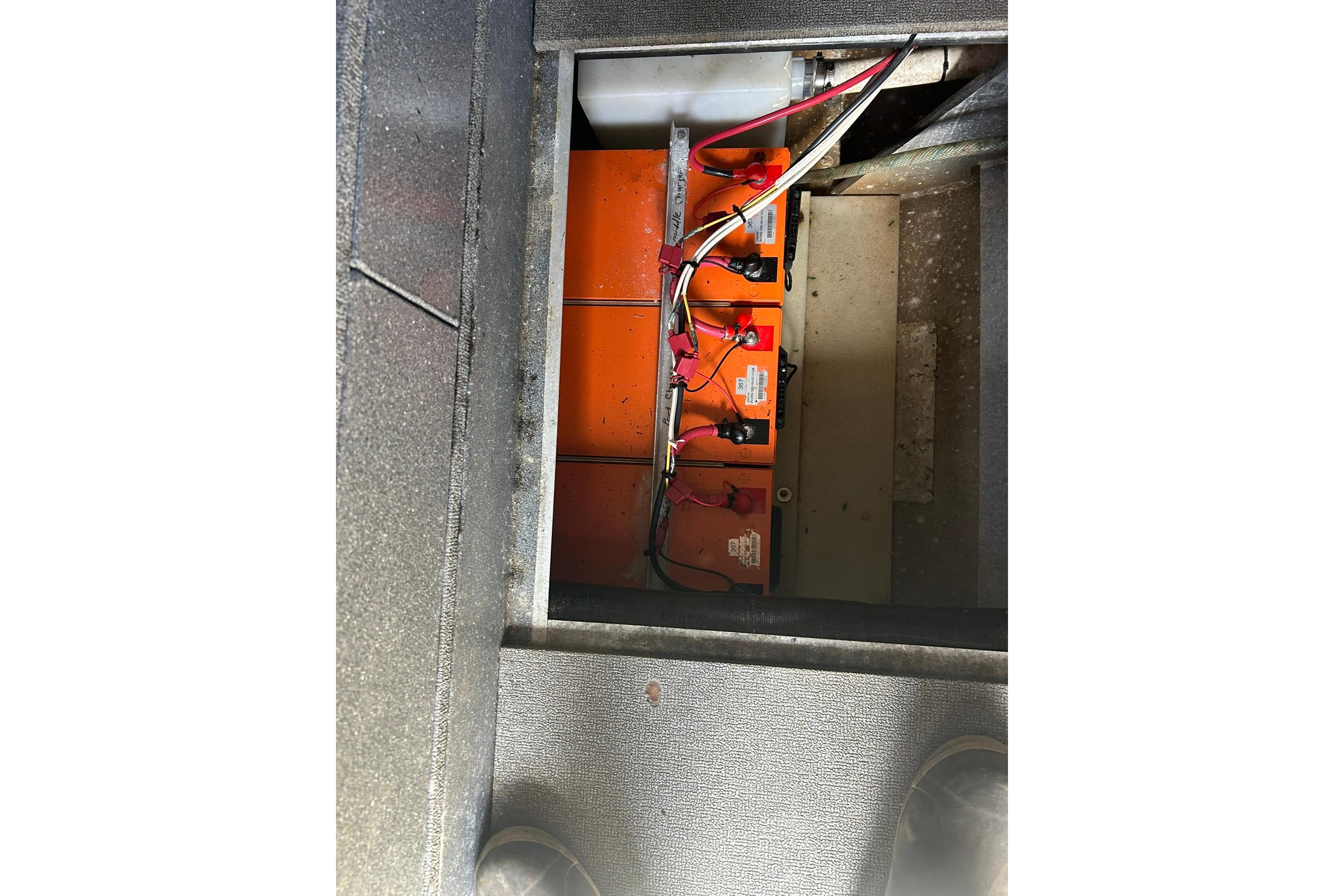 Battery compartment of a 2016 North River 29 Offshore boat, showing wiring and connections.