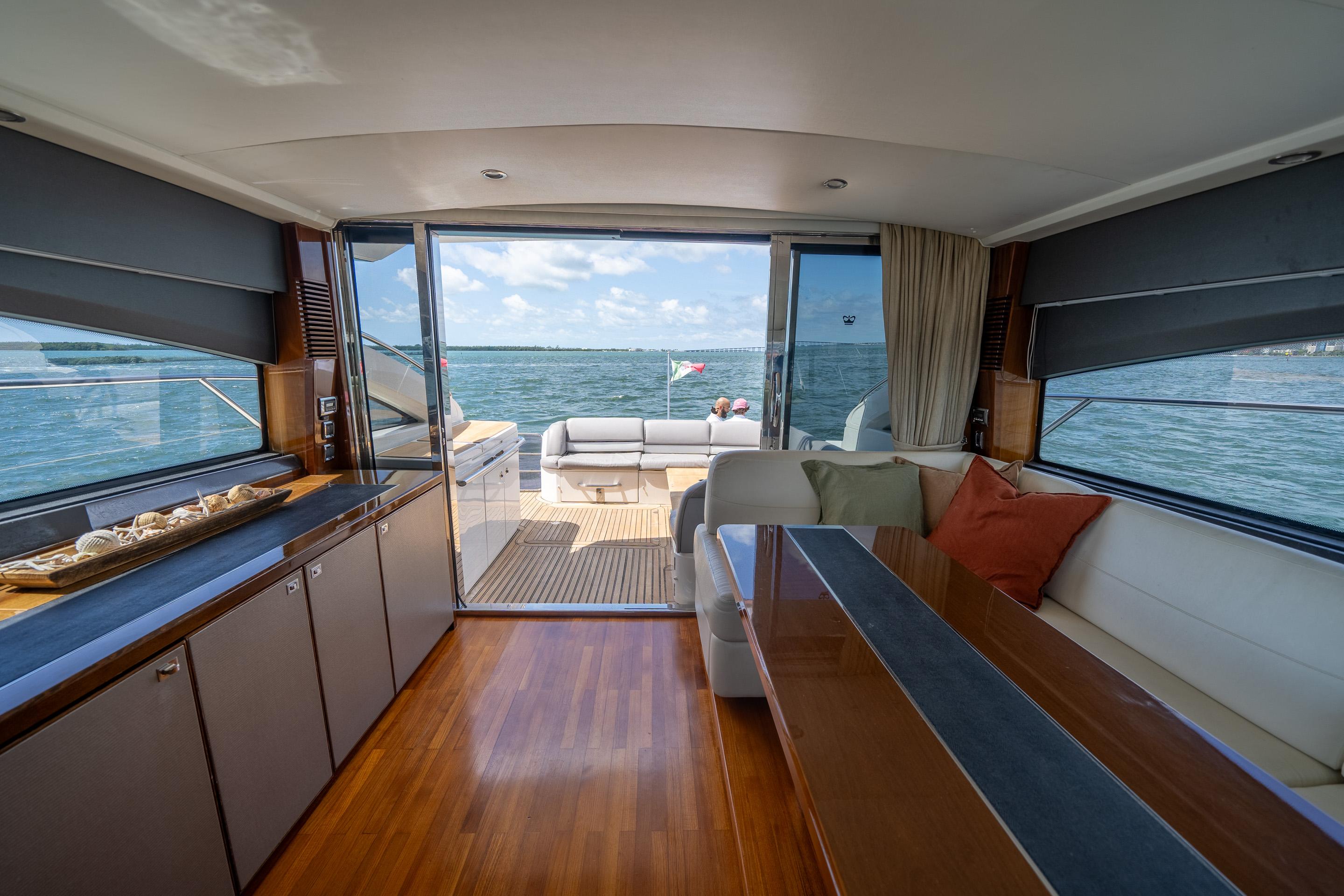 Luxurious interior of 2012 Princess V52 yacht with ocean view and elegant furnishings.