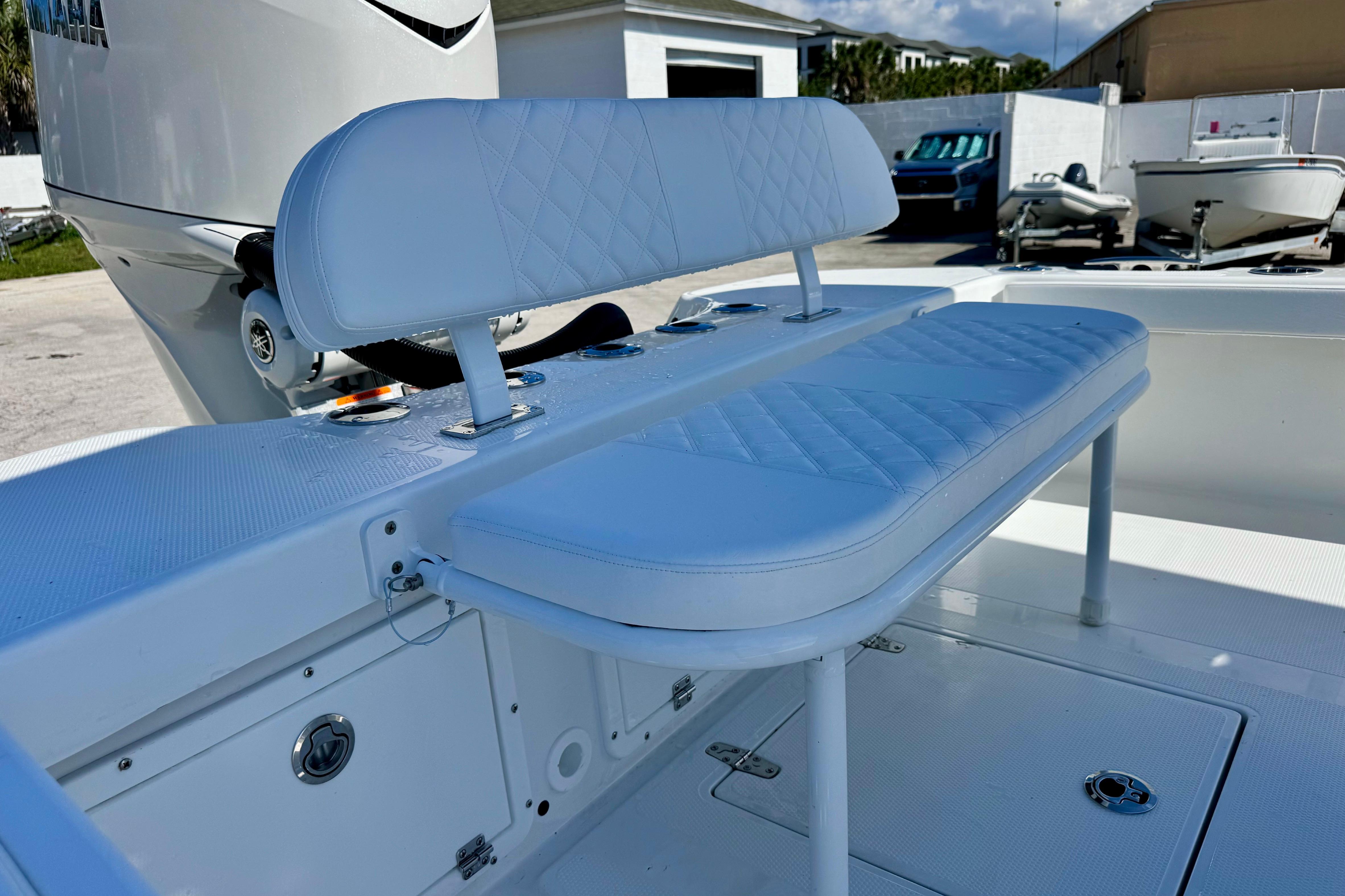2026 BlackJack 256 Coastal boat with white cushioned seating and Yamaha engine.