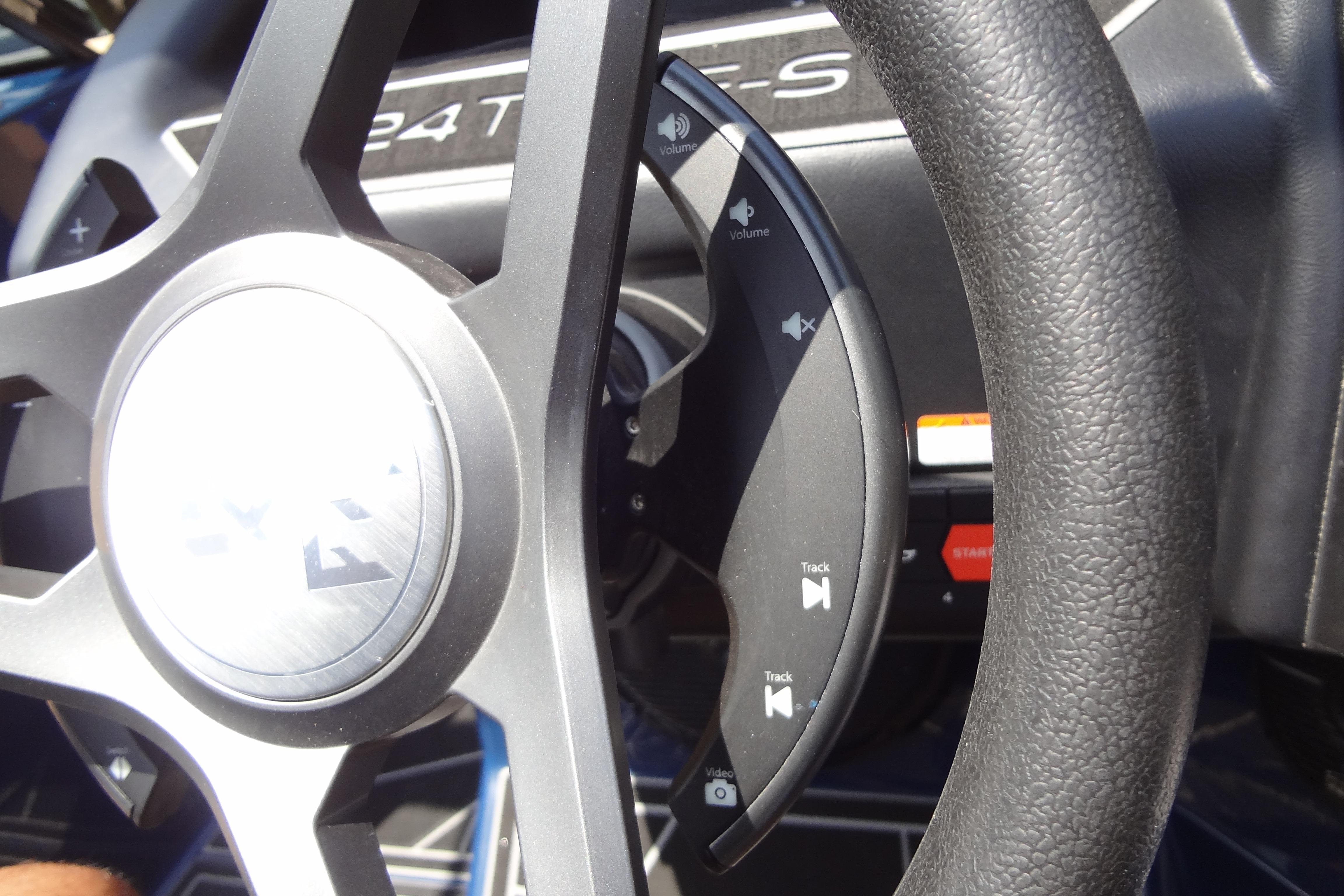 Steering wheel of 2022 ATX Surf Boats 24 Type-S with audio controls.