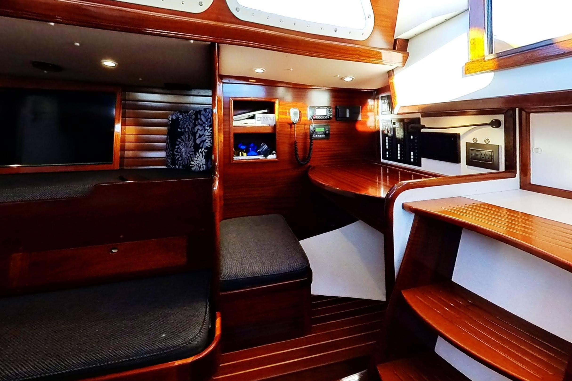 Interior of a 1970 Hinckley Bermuda 40 sailboat with polished wood and seating area.