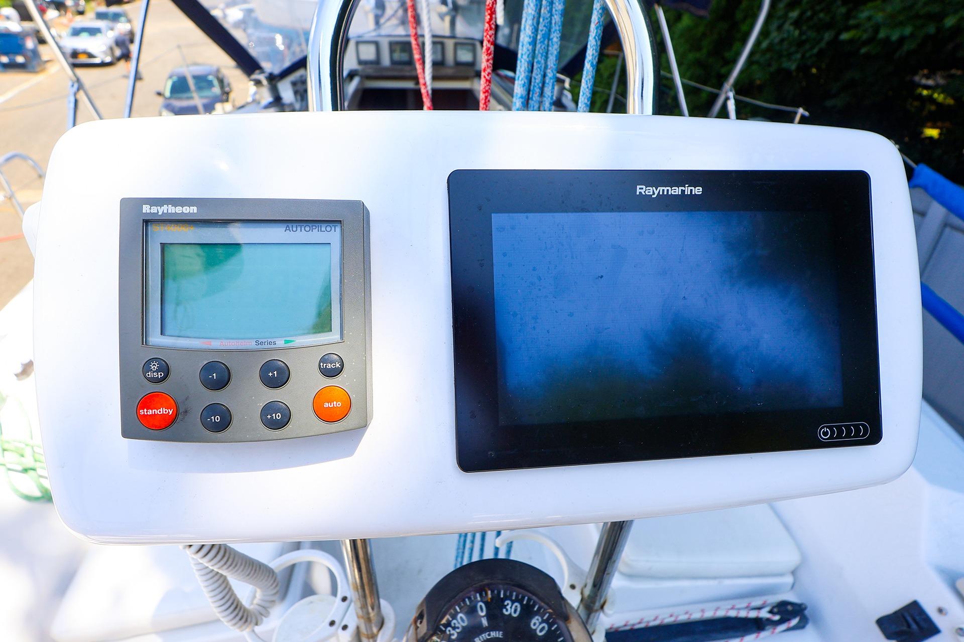 2001 J Boats J/32 cockpit with Raytheon autopilot and Raymarine navigation display.