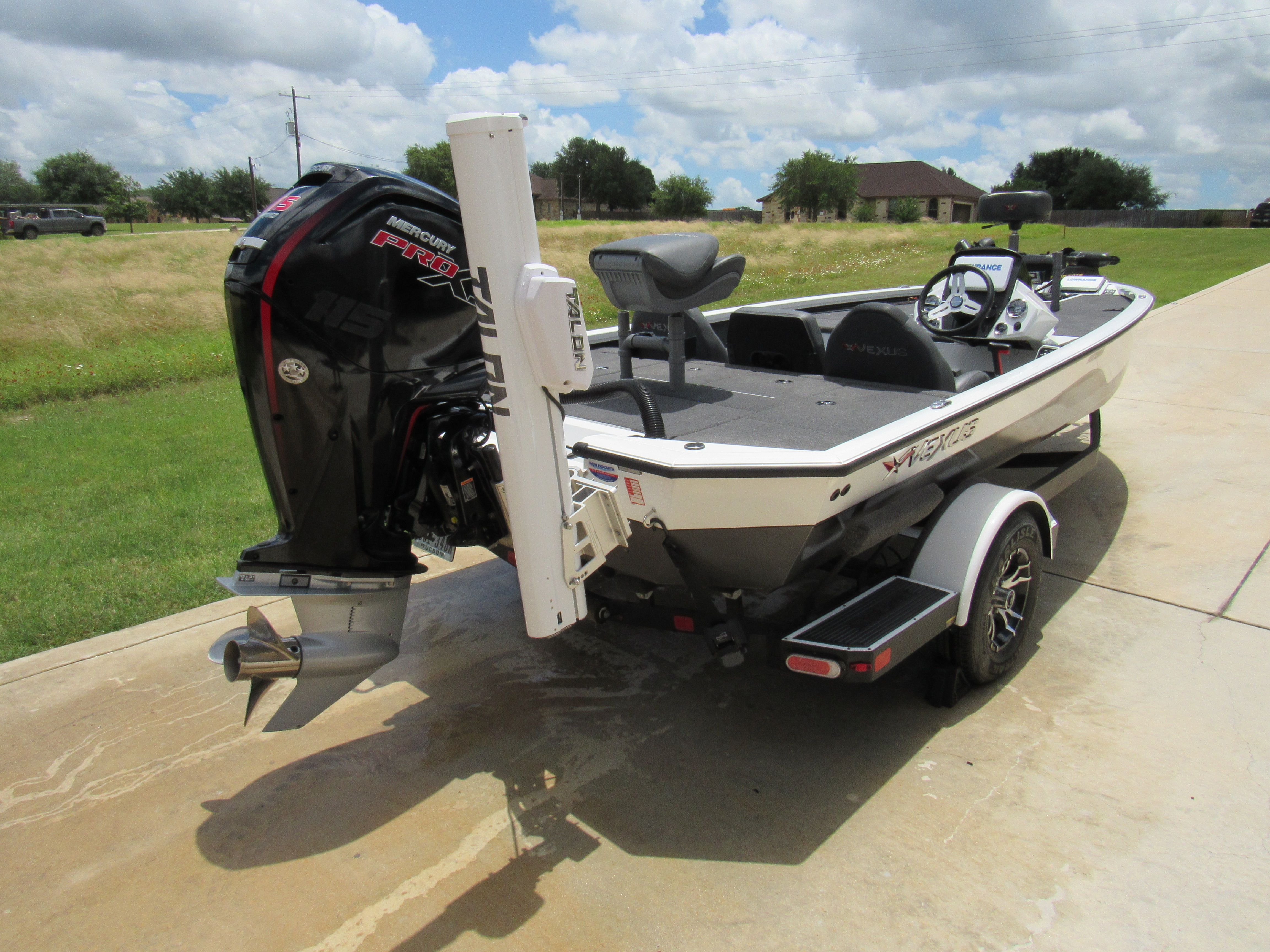 A 2019 Vexus AVX 1880 boat is on a trailer in a driveway.