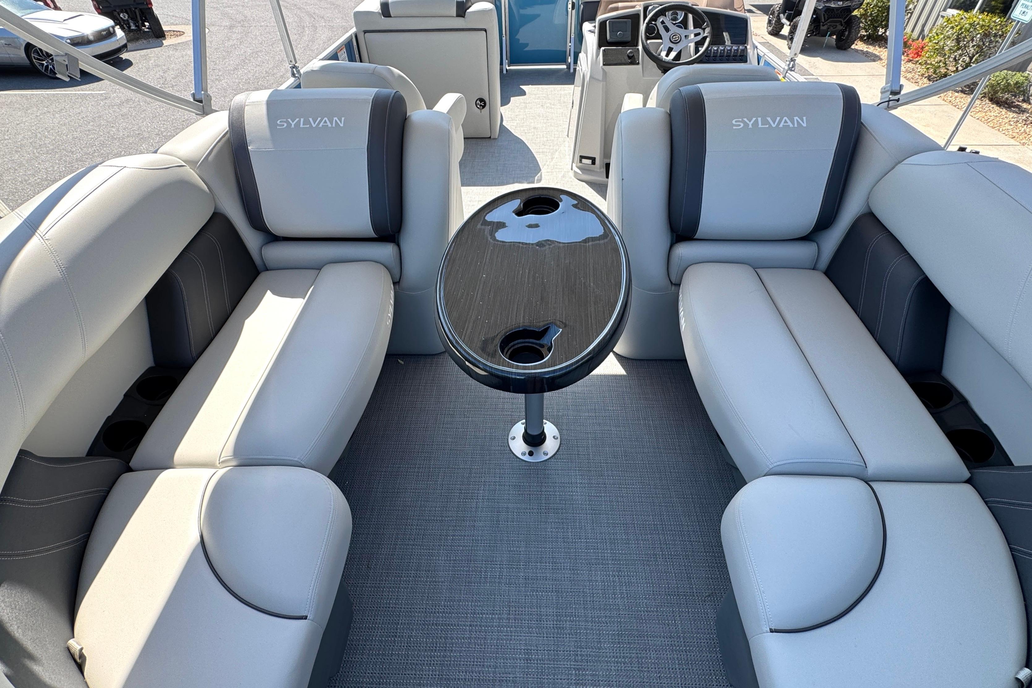 Interior of 2026 Sylvan Mirage 822 LZ pontoon boat with plush seating and table.