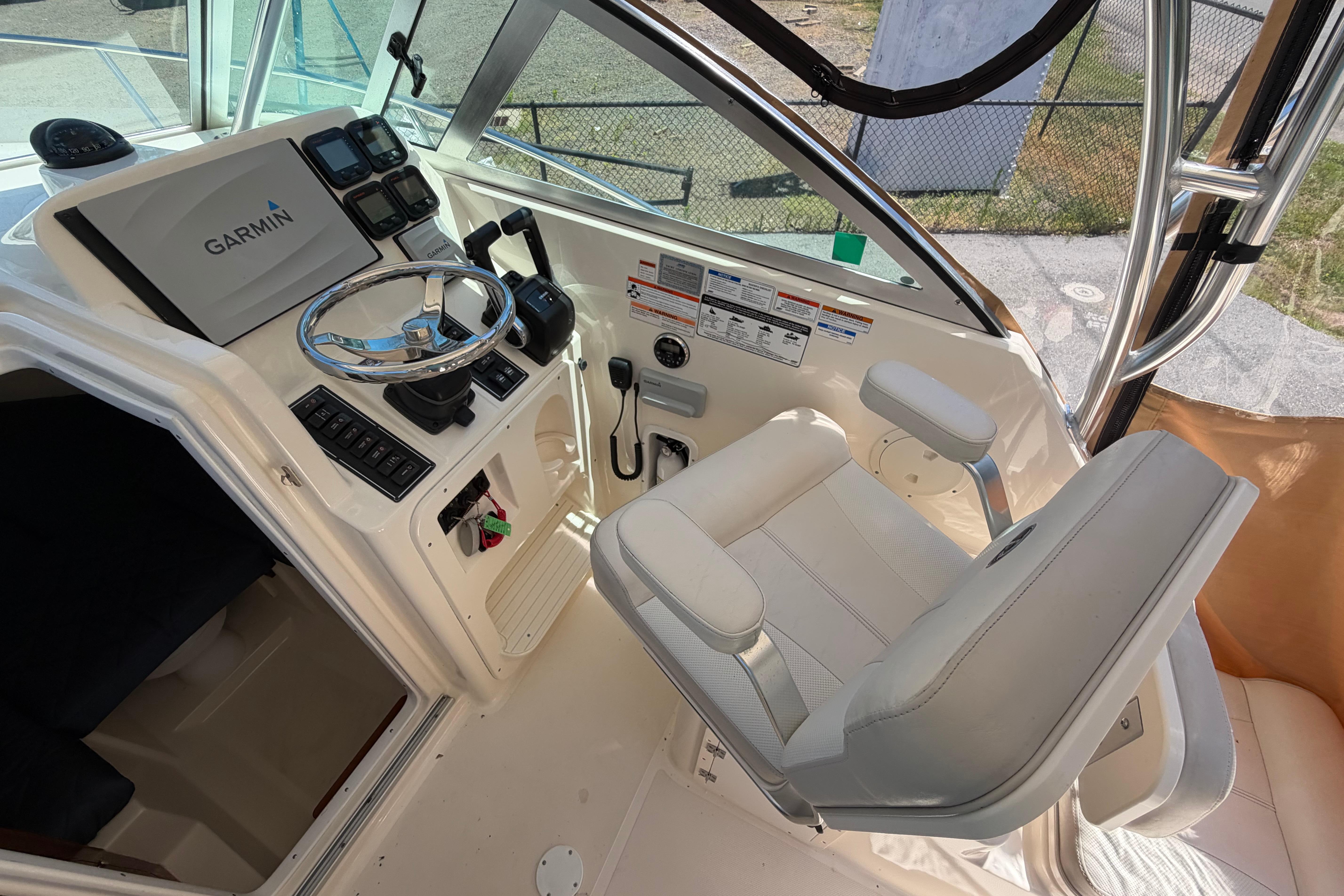 2010 Pursuit OS 255 Offshore boat helm with Garmin navigation system and captain's chair.