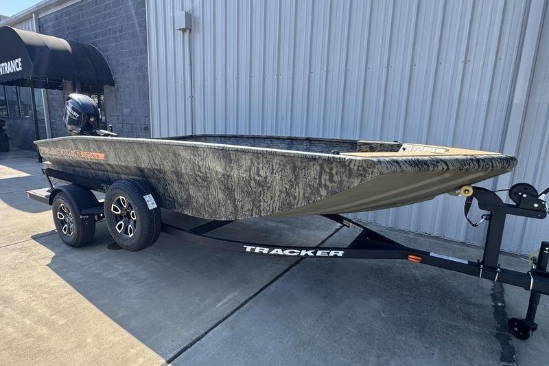 2026 Tracker Grizzly 1756 T Marsh boat on trailer, parked outside a building.