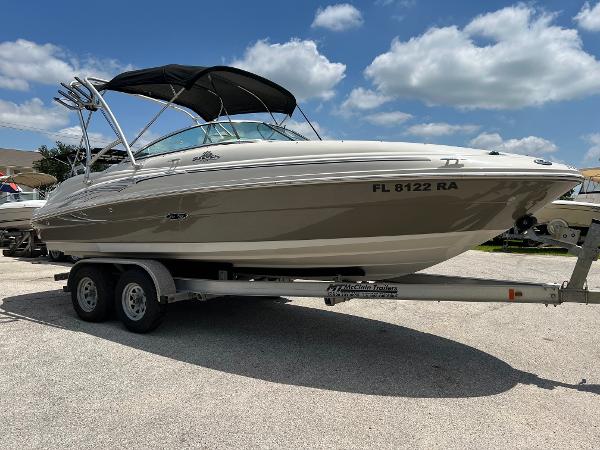 2005 Sea Ray 220 Sundeck boat on trailer under blue sky.