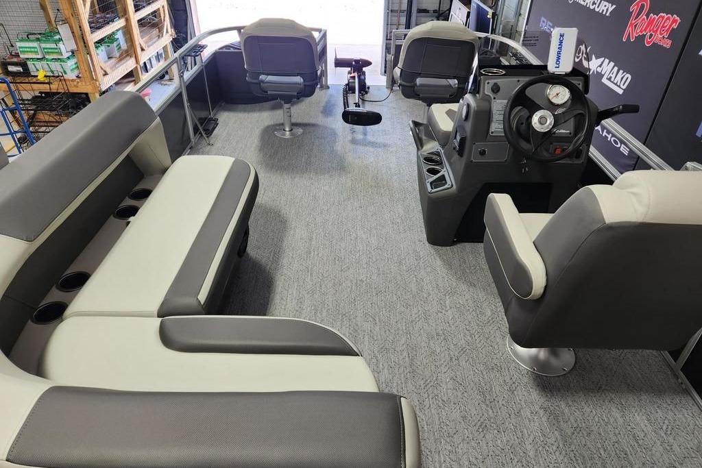 Interior of 2026 Sun Tracker Bass Buggy 18 DLX pontoon boat with seating and steering console.