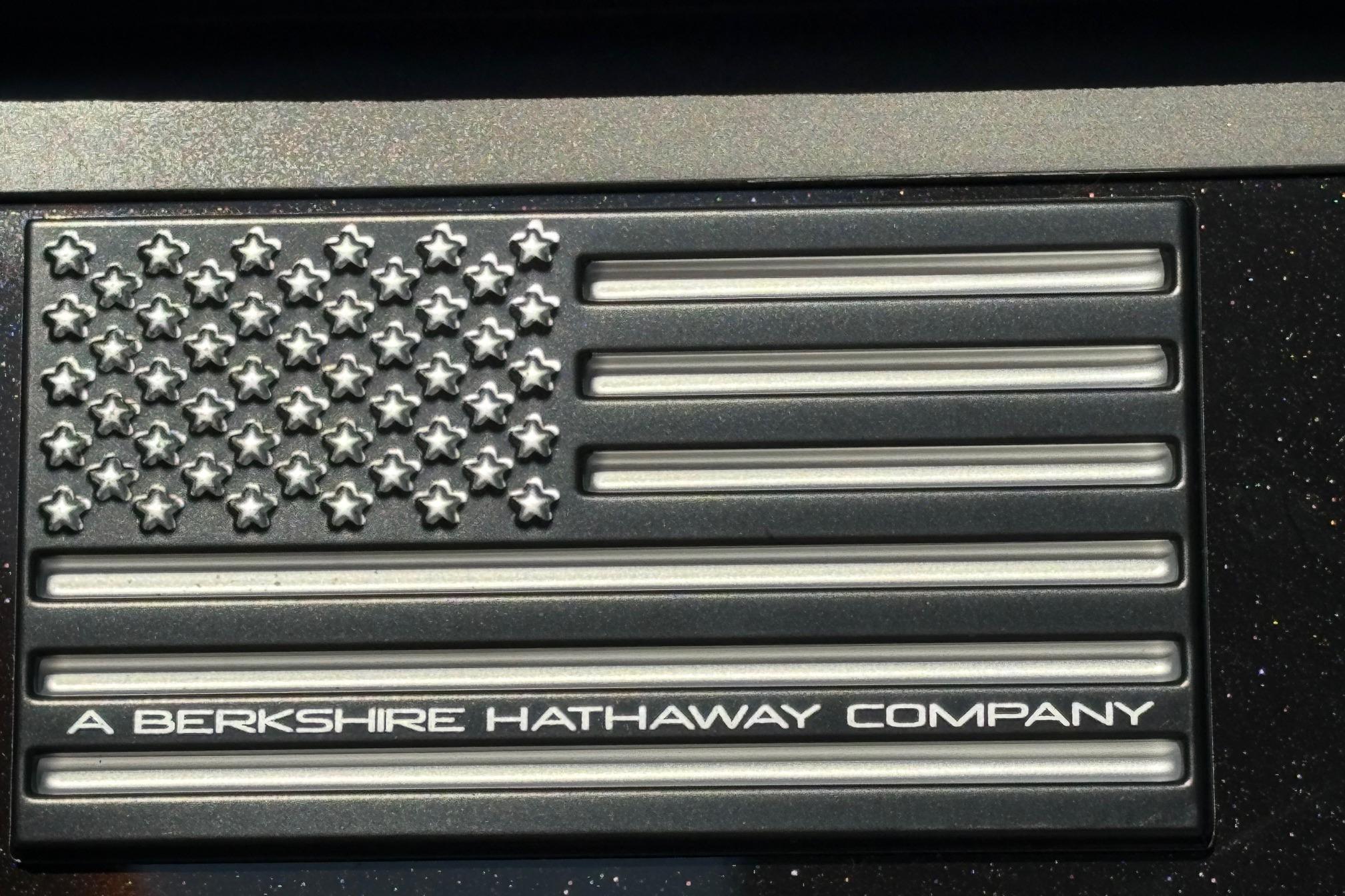 Metallic US flag emblem with Berkshire Hathaway inscription.
