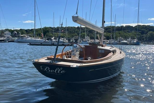 Sailboat "Belle" on water, Morris 36, 2006 model, sunny marina backdrop.