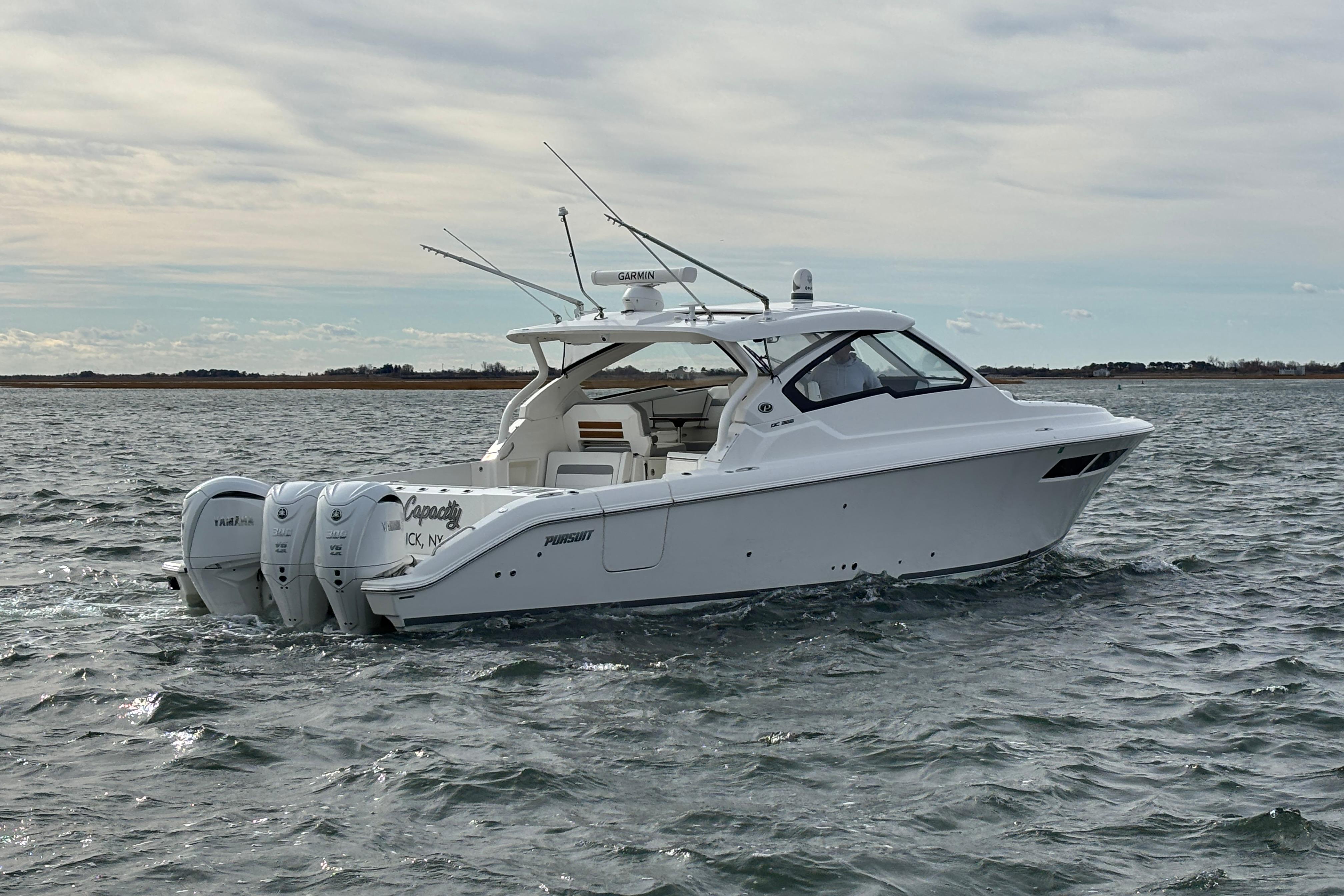 2022 Pursuit DC 365 Dual Console boat cruising on open water.