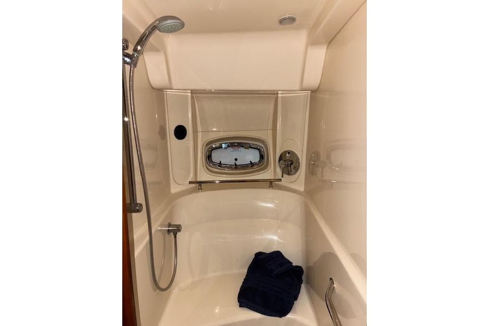 Luxurious bathroom in 2008 Sea Ray 48 Sundancer yacht with shower and porthole.