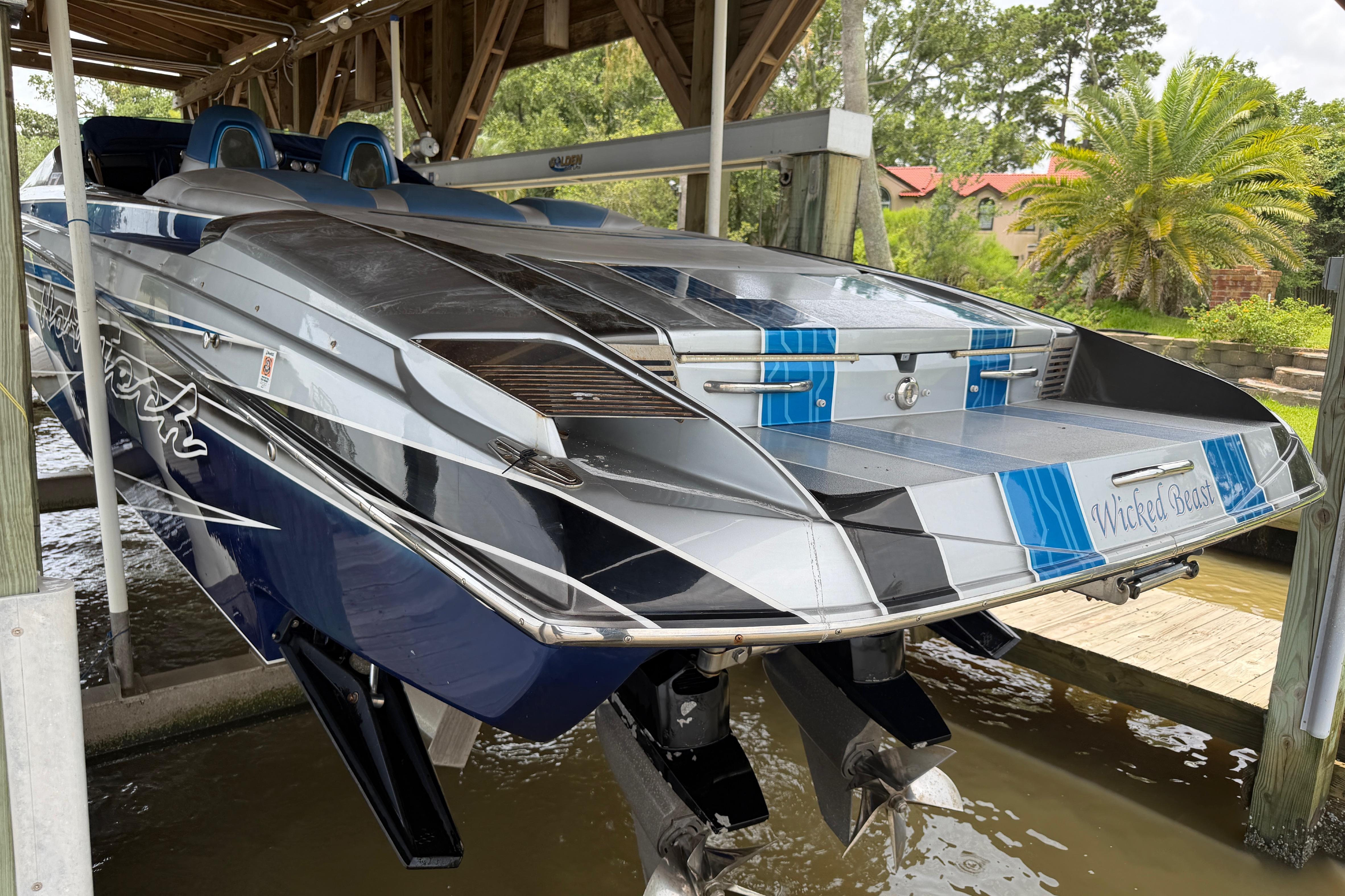 2013 Nor-Tech 477 SPX Vee Bottom boat docked, showcasing sleek design and vibrant colors.