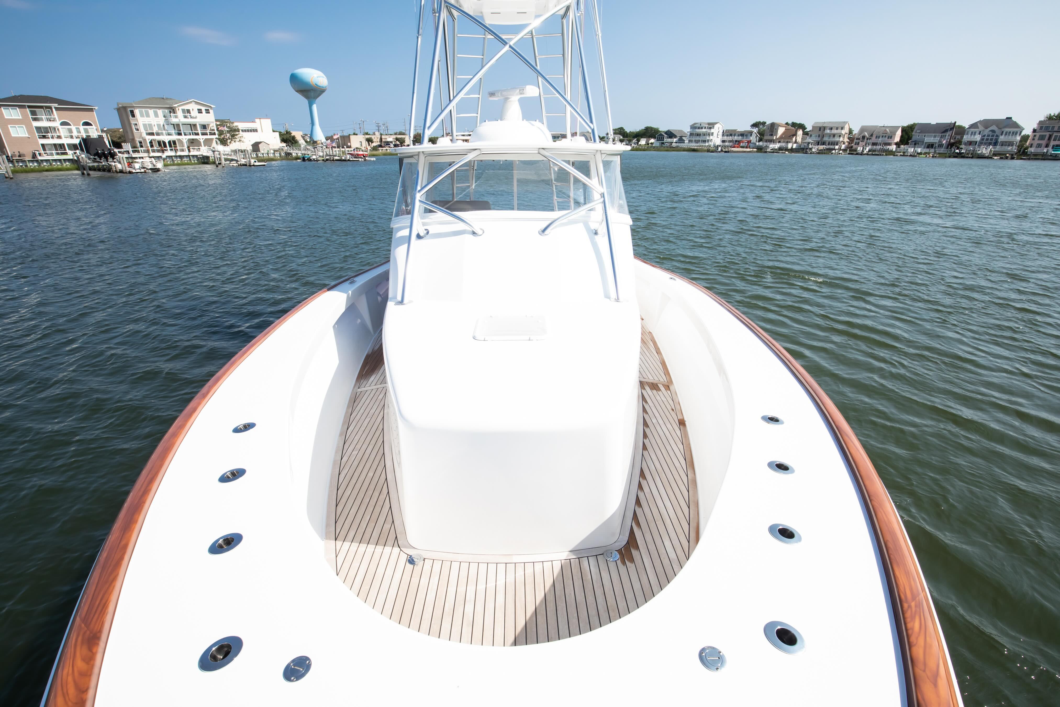 2026 Release Boatworks 46 Walkaround on calm water near coastal homes.