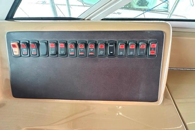 Control panel of a 2004 Carver 360 Mariner boat with multiple switches.