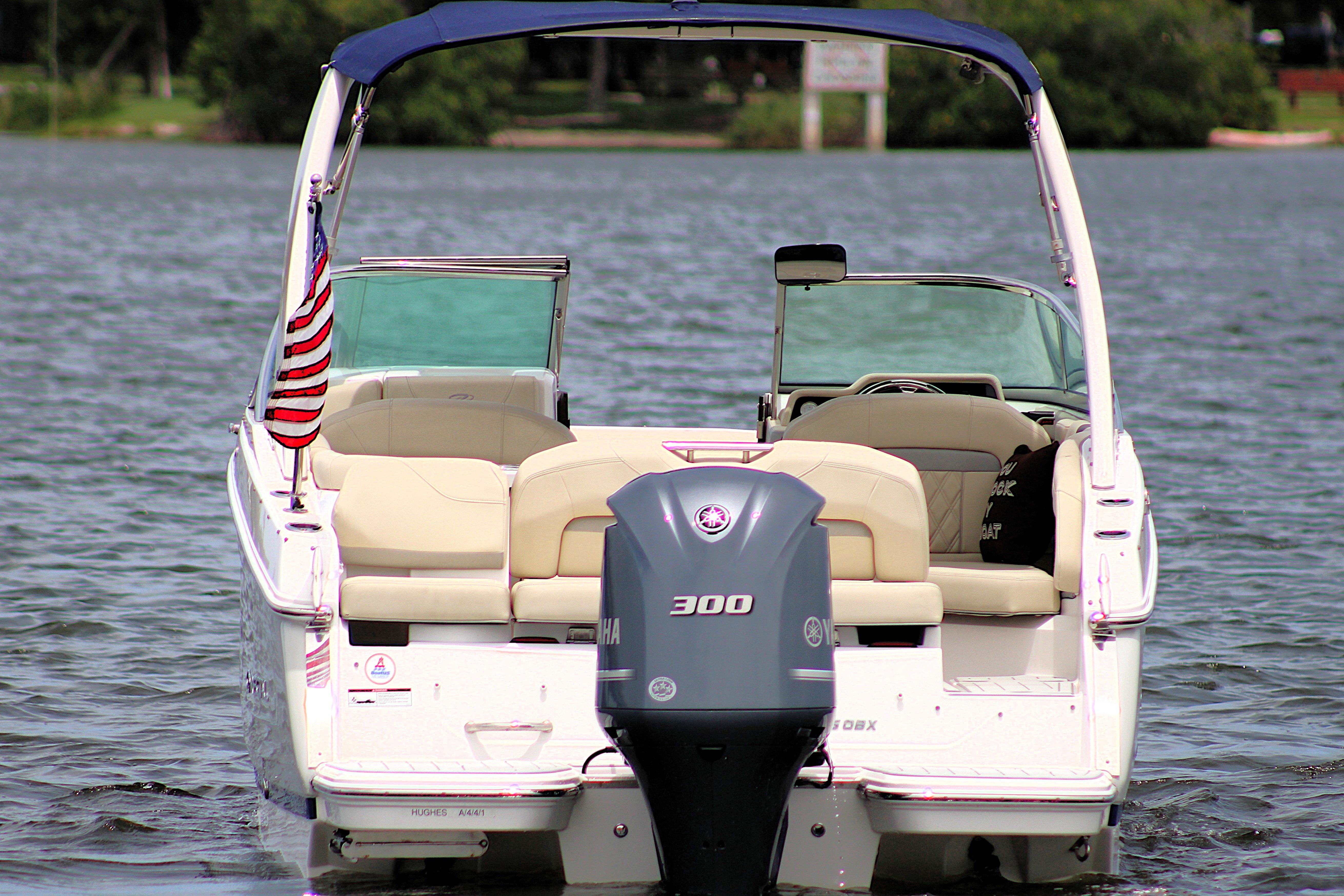 2021 Regal 26 OBX boat with outboard motor on a lake.
