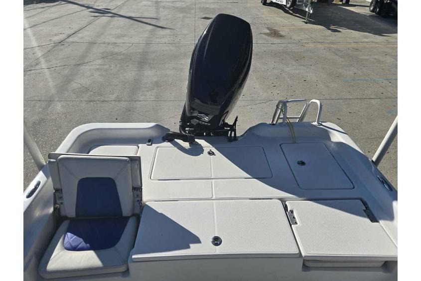 2020 Blue Wave 2400 PureBay boat deck with motor and seating area.