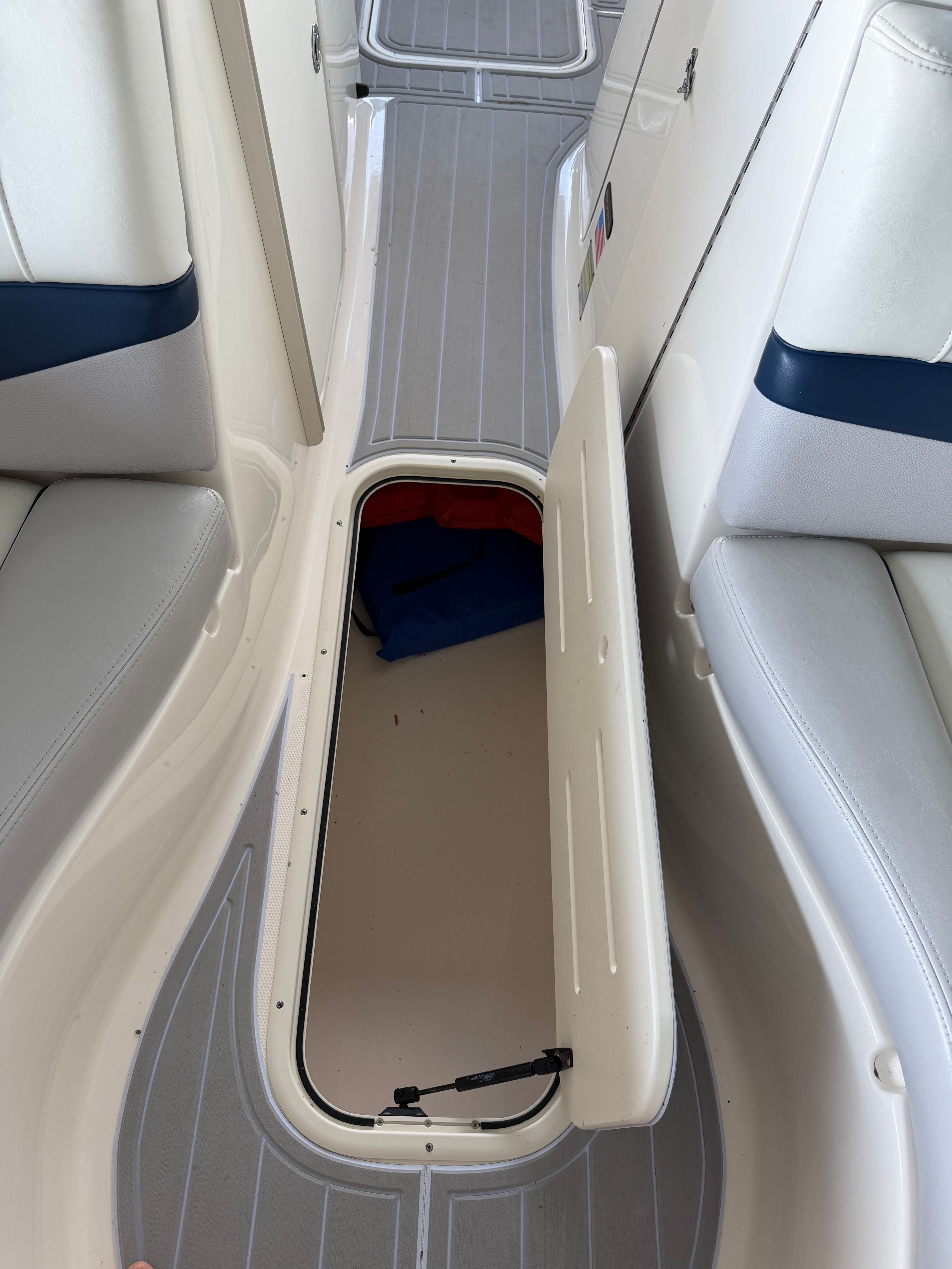 Open storage compartment in 2010 Bryant 255 boat.