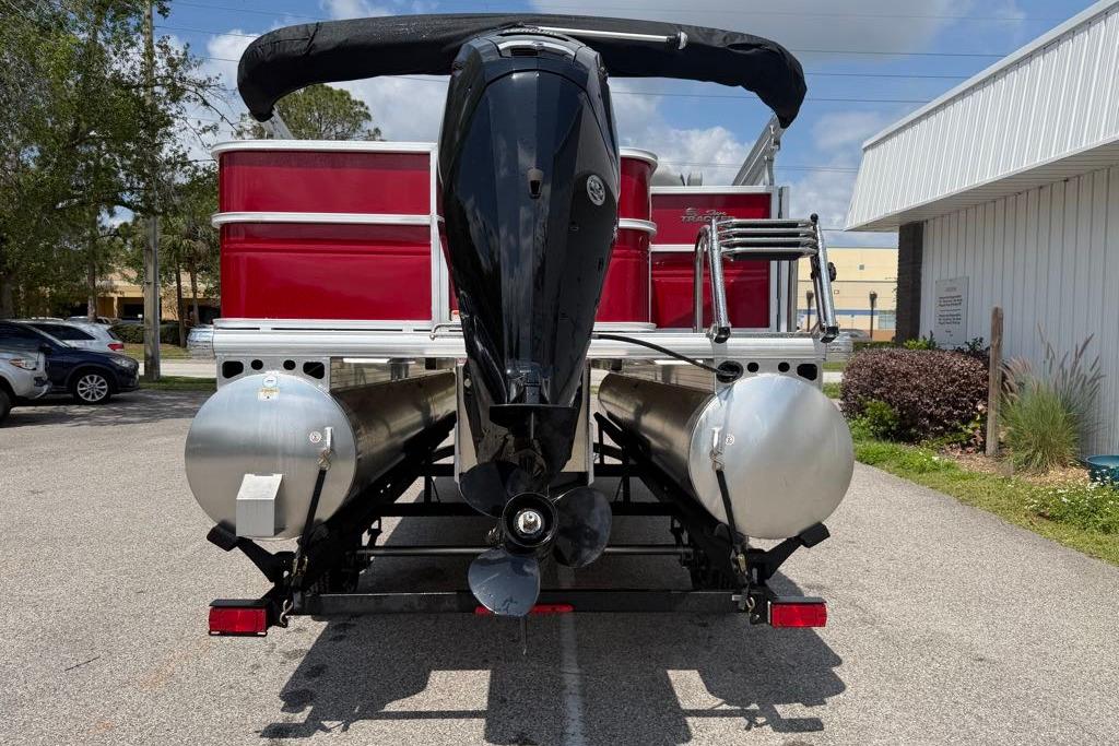 2026 Sun Tracker Party Barge 18 DLX pontoon boat, rear view with motor and ladder.