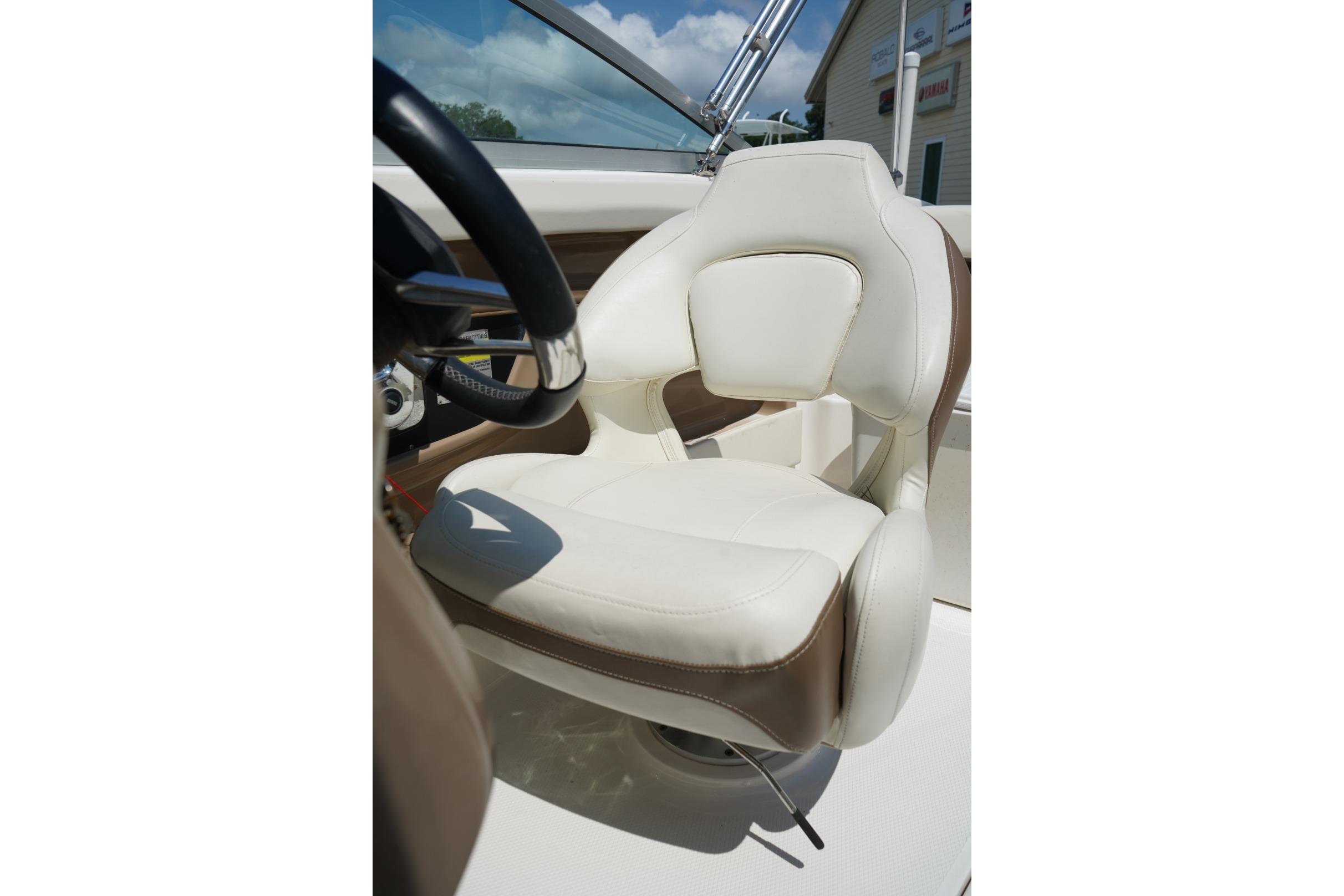 Captain's seat of 2013 Chaparral 206 SSi boat, featuring white and brown upholstery.