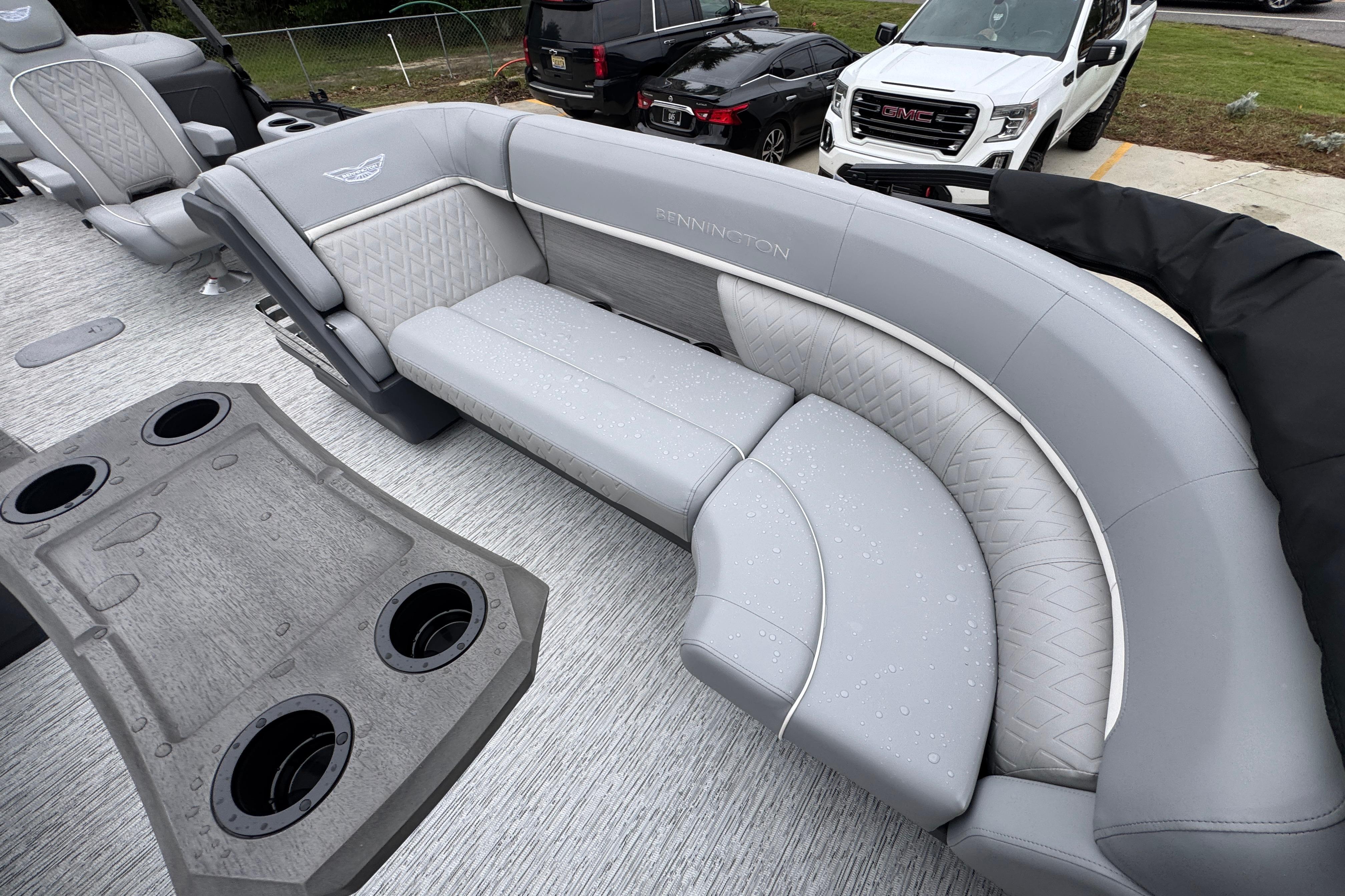 2027 Bennington 24 MFB boat interior with gray seating and cup holders.