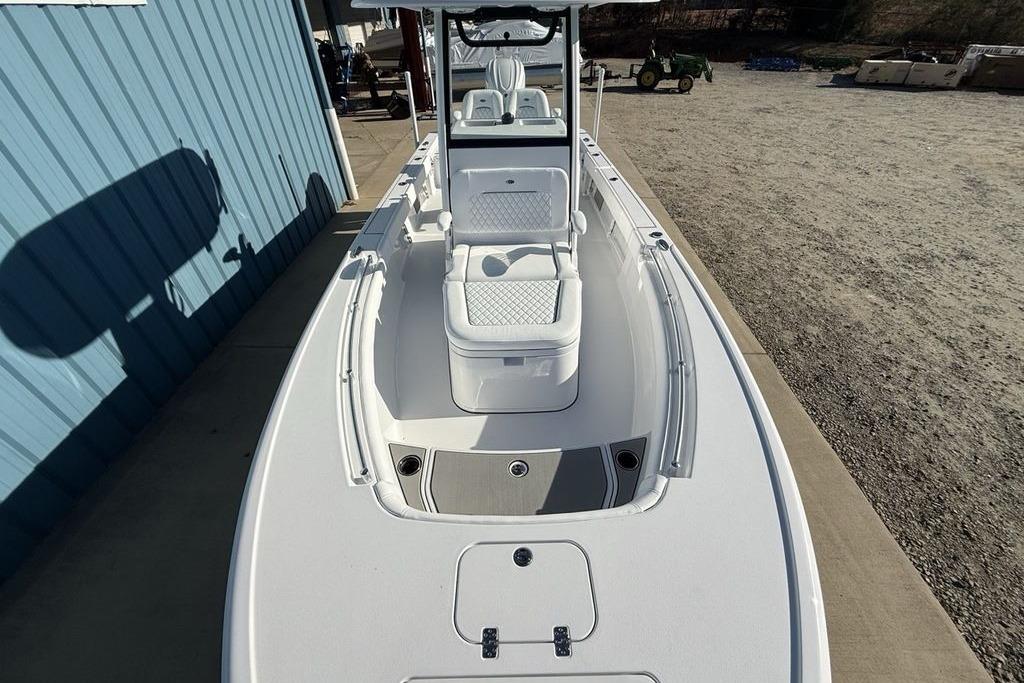 2026 Sportsman Masters 247OE Bay Boat, sleek design, docked near blue building.