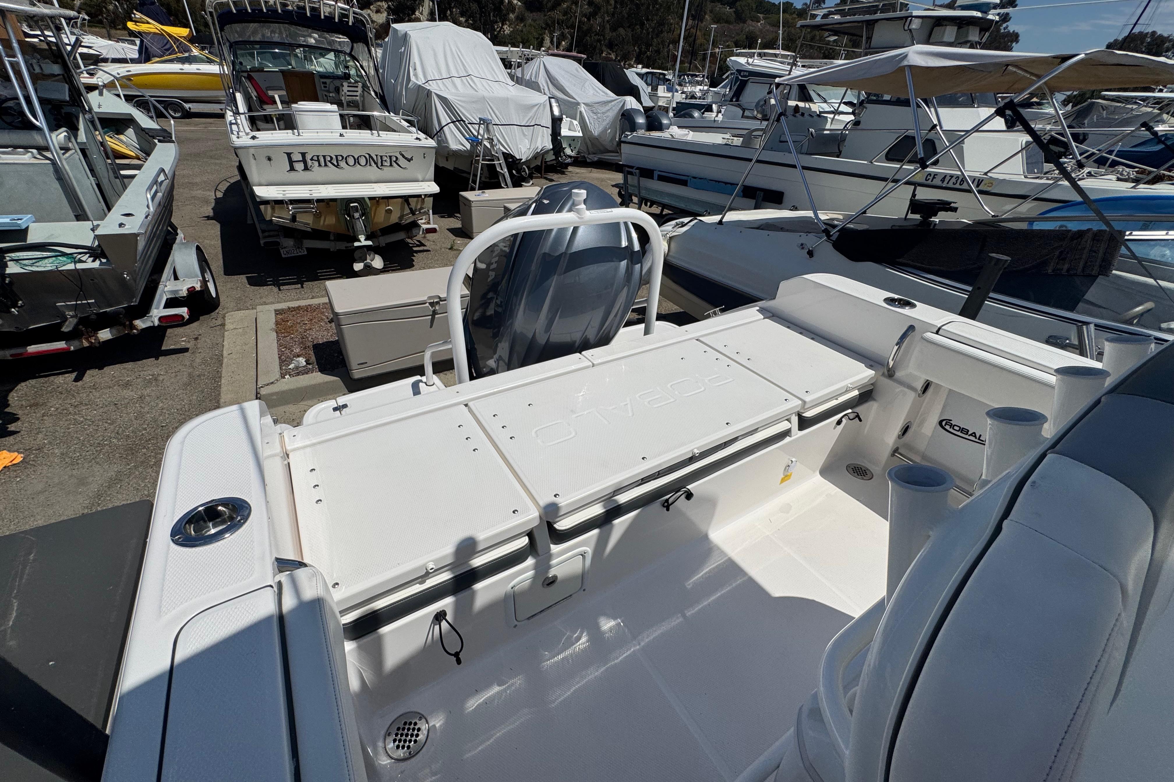 2022 Robalo R230 Center Console boat in a marina, showcasing spacious deck and seating.