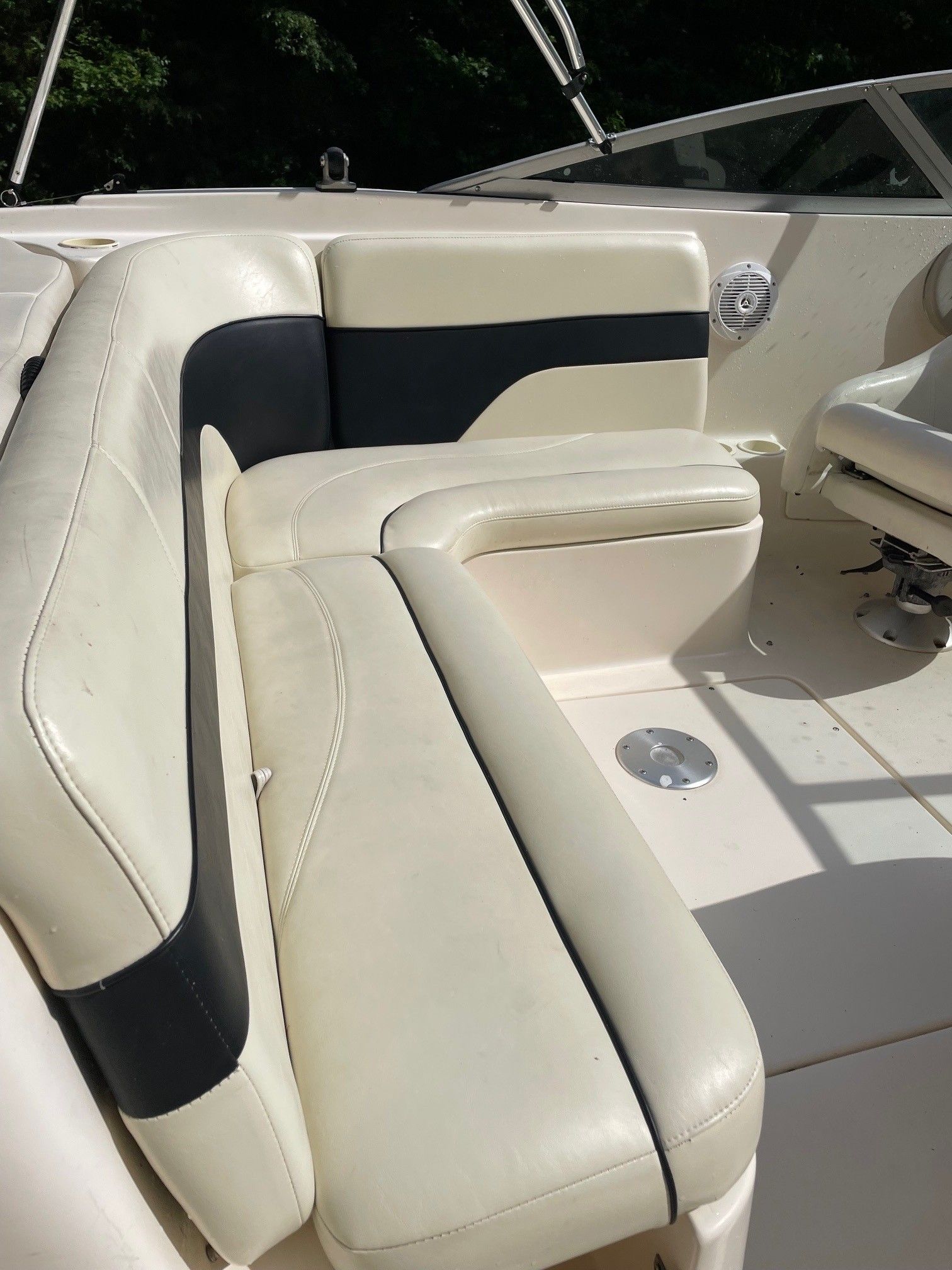 Interior of a 2002 Rinker 212 Captiva Bowrider with beige seating.