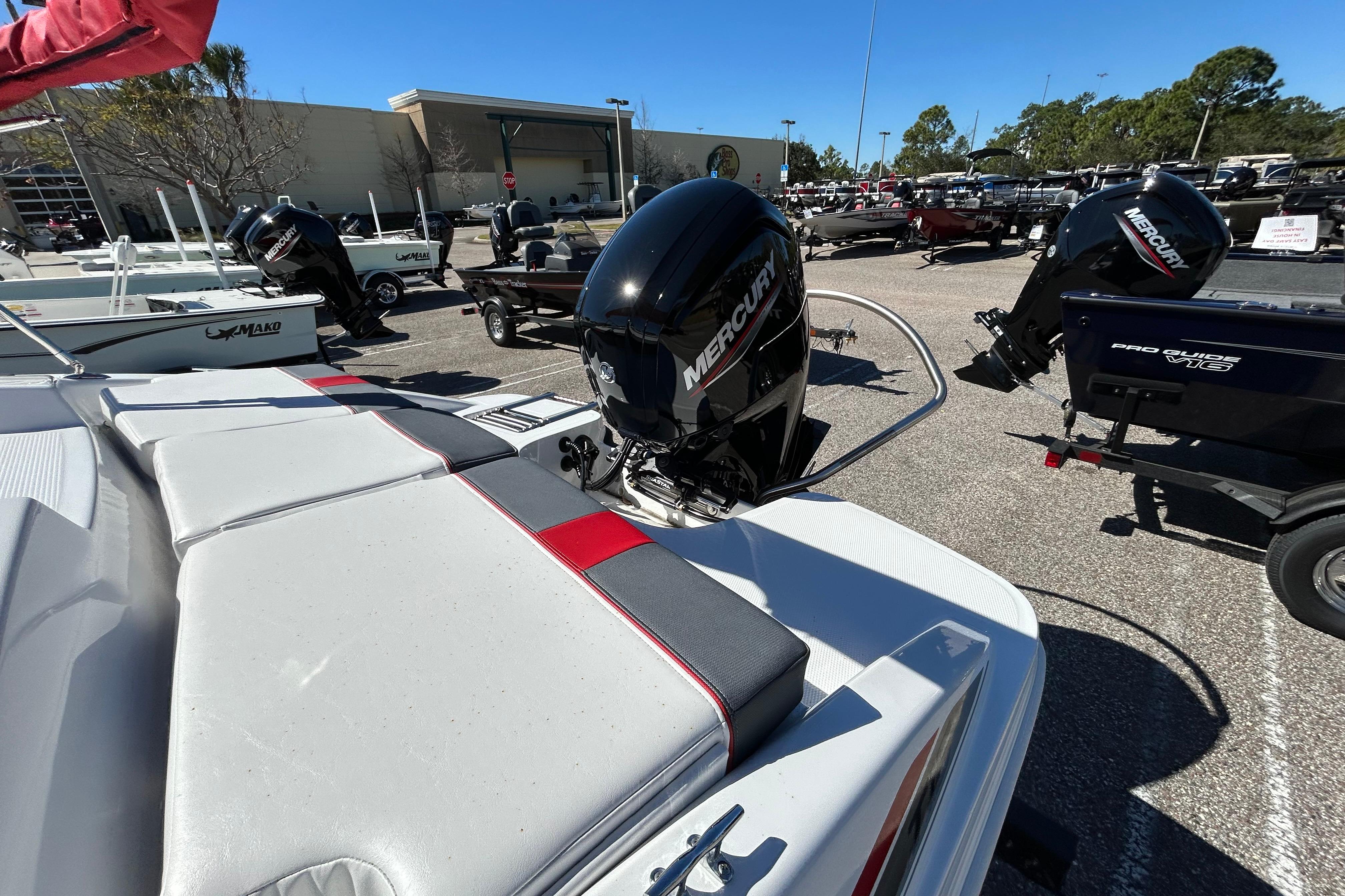 2026 Tahoe T16 boat with Mercury outboard motor in a dealership lot.