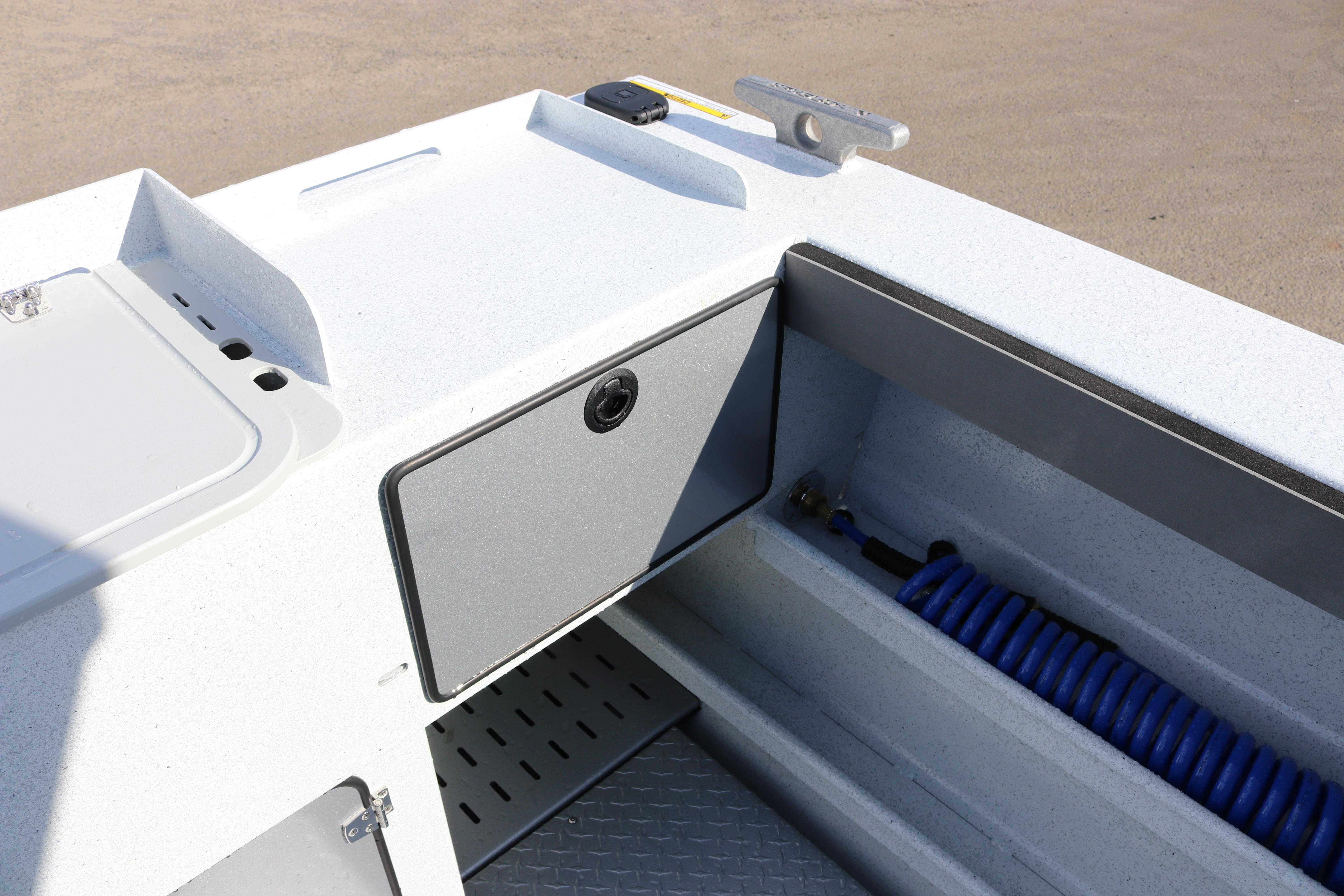 2026 KingFisher 2425 Escape HT boat interior with storage compartment and coiled hose.