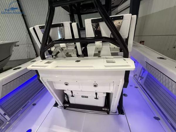 2025 Blackfin 272CC boat interior with seating and storage, featuring blue LED lighting.