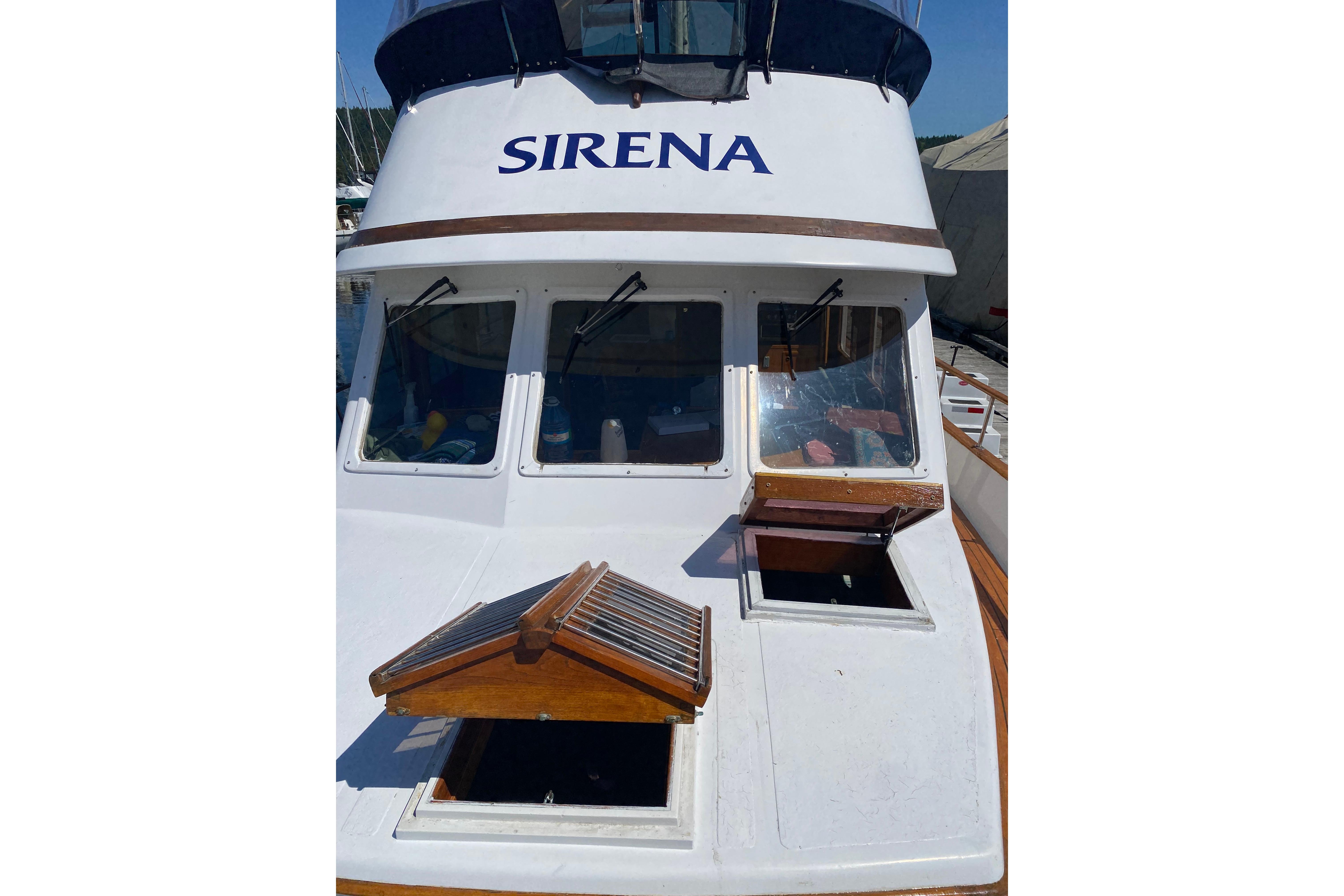 1979 Albin 43 Trawler "Sirena" with open hatches, docked under clear skies.
