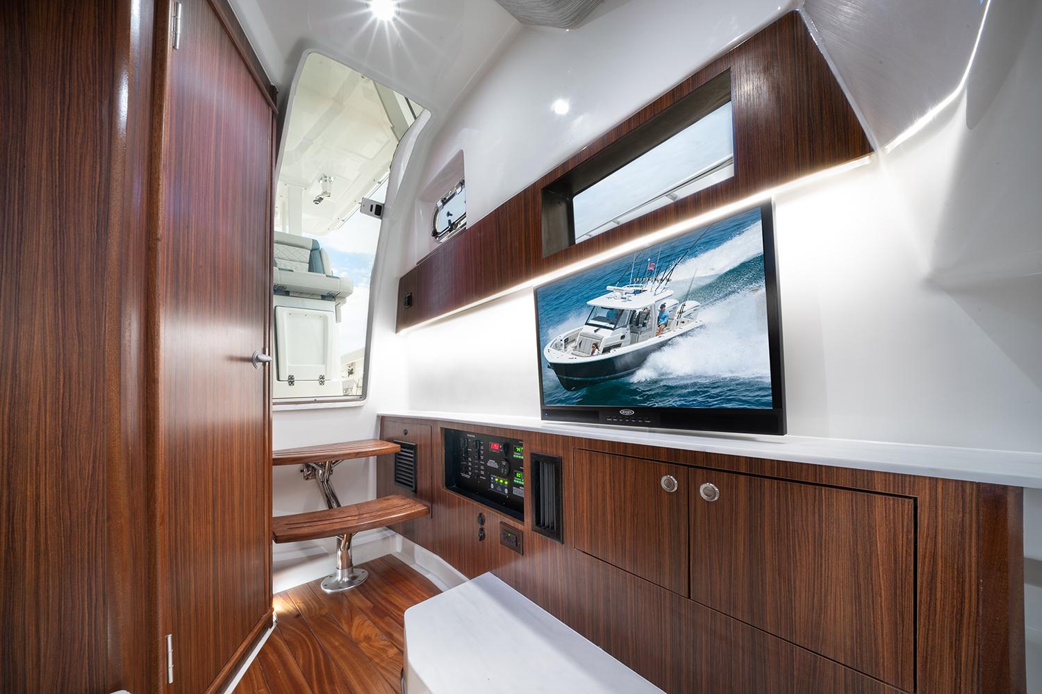 Manufacturer Provided Image: Luxurious interior of 2025 Pursuit S 358 Sport boat with wood finishes and modern amenities.