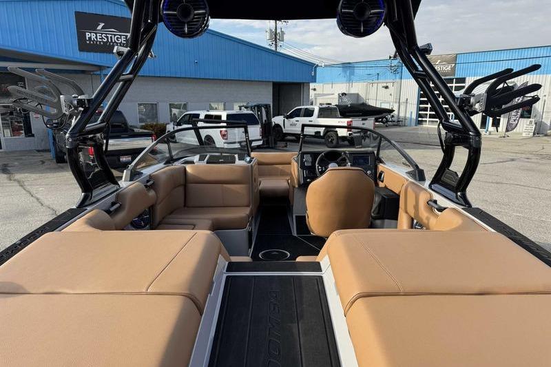2026 Moomba Mondo boat interior with tan seating, parked at a dealership.