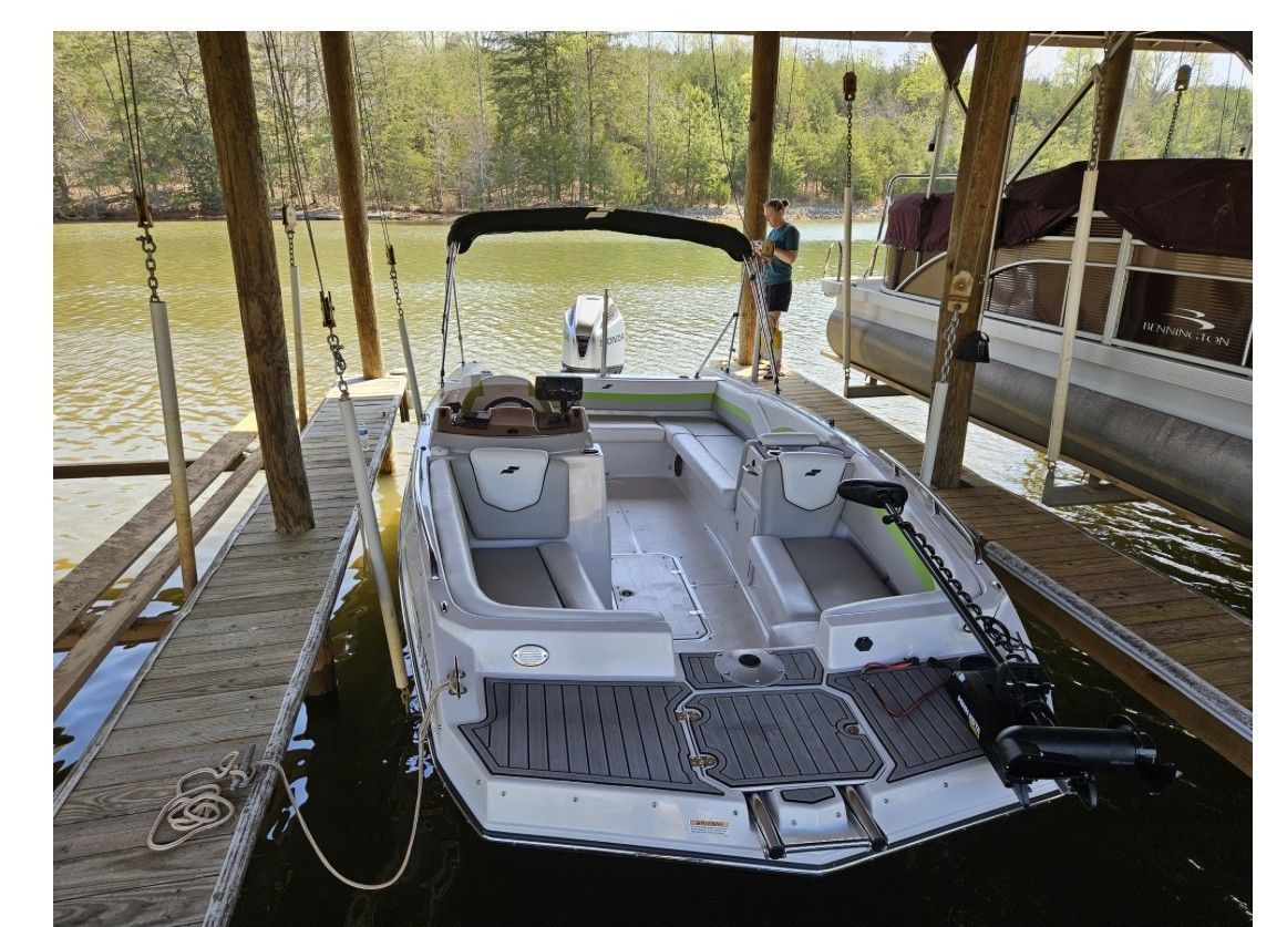 2023 Starcraft SVX 211 boat in a covered dock.