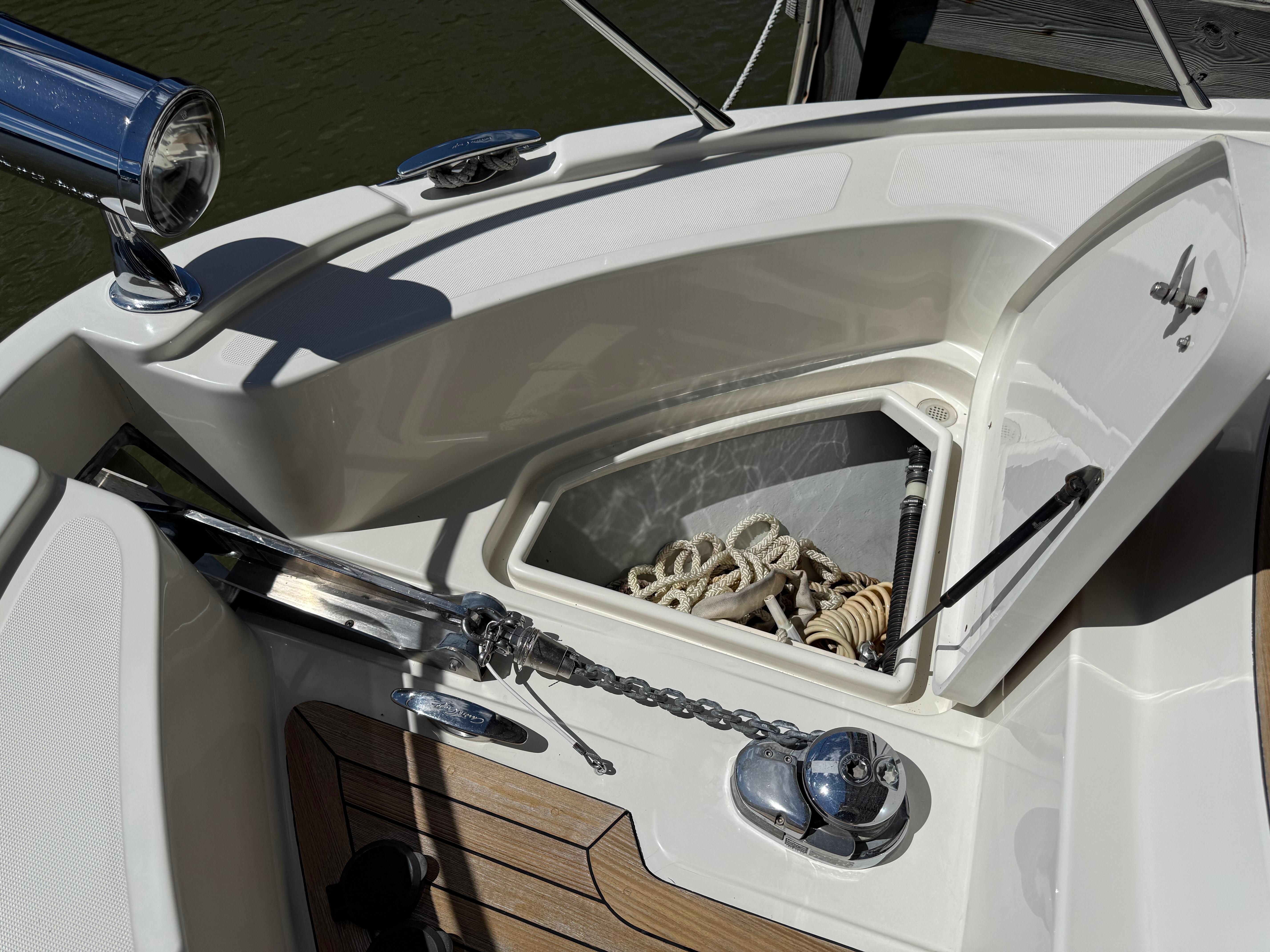 Foredeck of a Chris-Craft Roamer 40 with anchor locker and ropes.