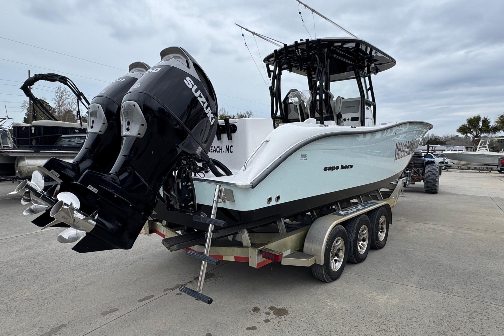2024 Cape Horn 32 XS boat with dual Suzuki engines on a trailer.