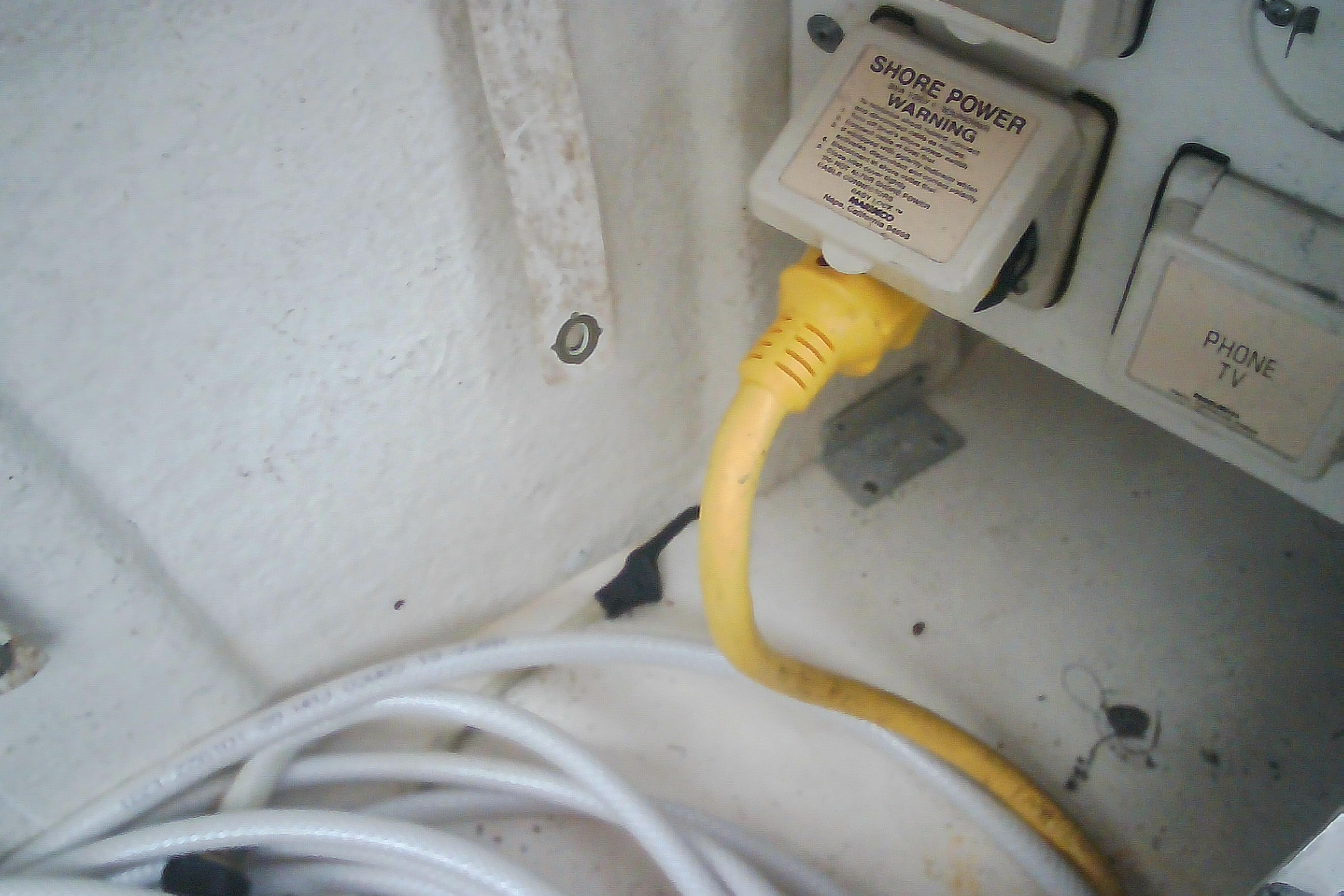 Yellow shore power cable connected on 2005 Sea Ray 300 Sundancer boat.